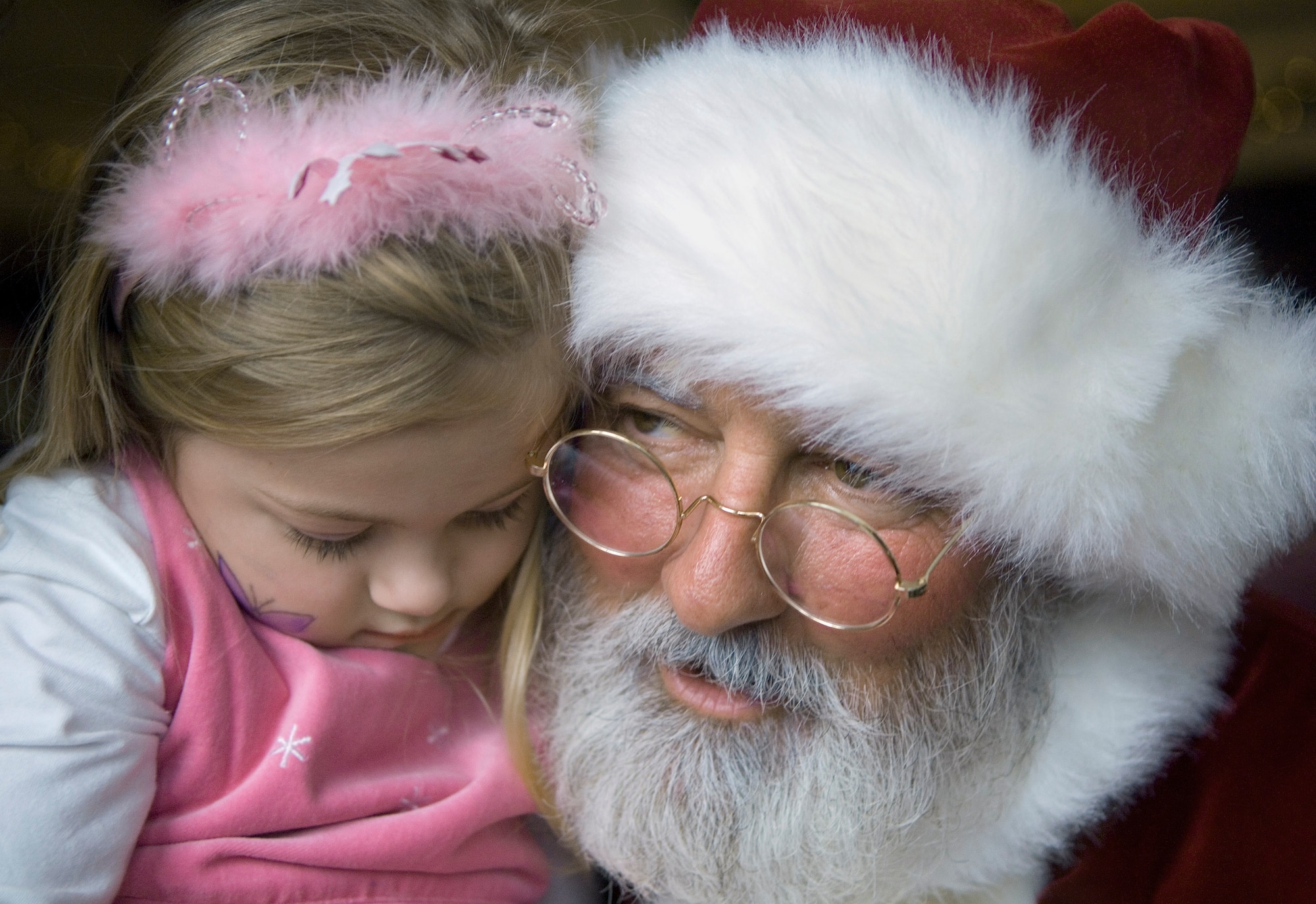 Santa whispers to a young girl during the Christmas party Dec. 2 at Arnold Air Force Base, Tenn. (U.S. Air Force photo/Staff Sgt. Bennie J. Davis III)