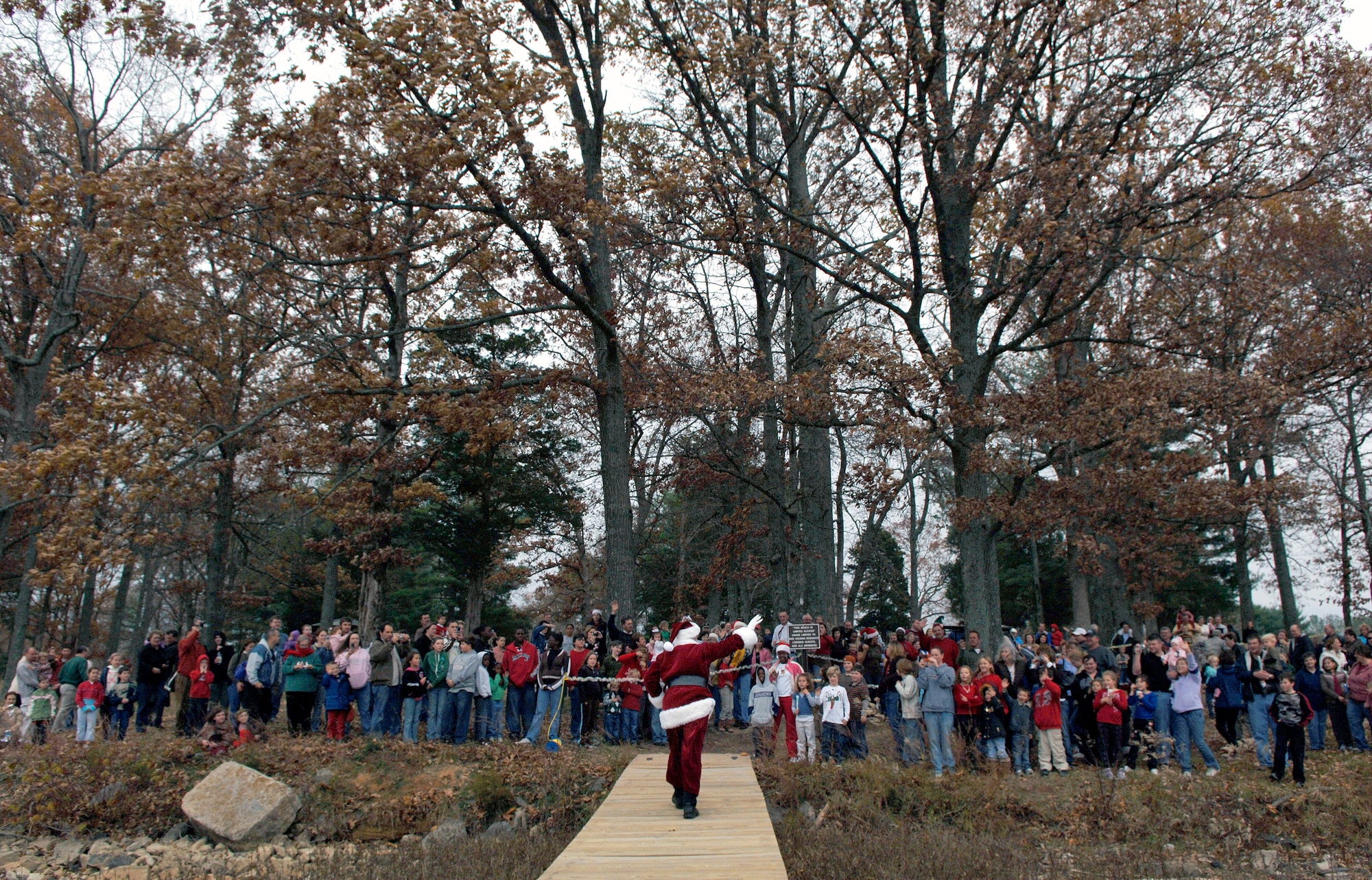 Santa Claus greets well-wishers lining the shore of the base lake at Arnold Air Force Base, Tenn., Dec. 2 after arriving on a small amphibious aircraft.  Santa was there for the annual holiday Christmas party at Arnold's Lakeside Club.  (U.S. Air Force photo/Staff Sgt. Bennie J. Davis III)
