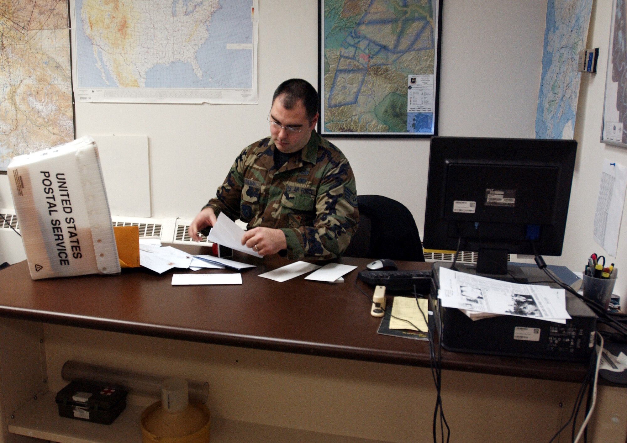EIELSON AIR FORCE BASE, Alaska - Staff Sgt. Matthew Bohlman, 354th Operations Support Squadron weather technician, reads a letter from a child addressed to Santa Claus as a part of the Santa's Mailbag program here at Eielson AFB, Alaska, Nov. 26, 2007. The 354th OSS's Santa's Mailbag program reads and responds to letters written from children all over the world. This program has been active for 53 years and is a holiday tradition for the men and women of the 354th Operation Support Squadron. (U.S Air Force photo by Staff Sgt Eric T. Sheler)
