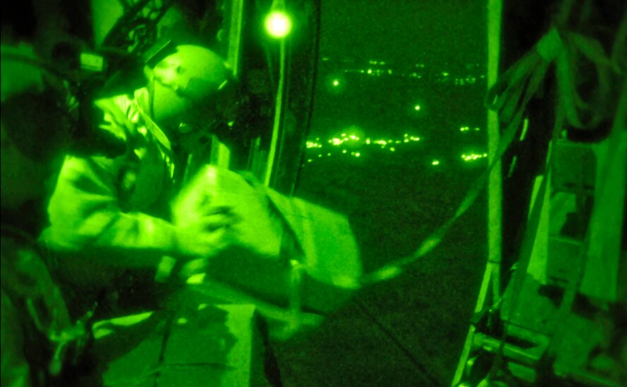 Senior Airman Brandon Fertig and Tech. Sgt. Alex Garrett, loadmasters deployed to the 40th Expeditionary Airlift Squadron at an air base in Southwest Asia, throw a box of leaflets out the door of a C-130 Hercules over a designated airdrop zone.  The leaflets provide coalition forces on the ground with a means to communicate with citizens in the area to aide in the capture of insurgents.  The Airmen are deployed from Dyess Air Force Base, Texas.  (U.S. Air Force photo/Staff Sgt Angelique Perez)