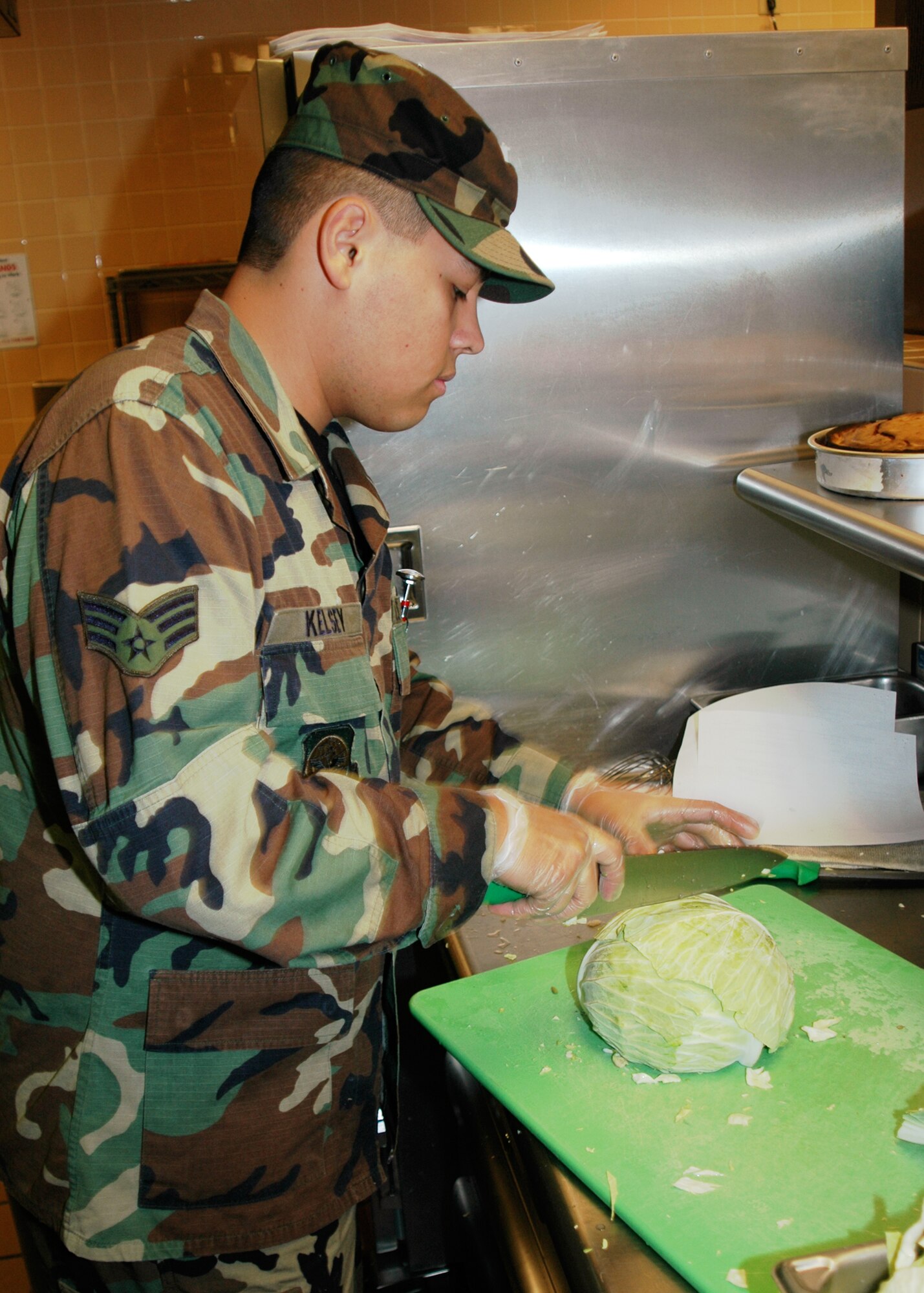 GRISSOM AIR RESERVE BASE, Ind., -- Sanitation is one of the areas that the 434th Services Flight will be judged on during the John L. Hennessy competition. Here Senior Airman Matthew Kelsey, 434th SVF member, wears gloves and a hat while preparing food. The Hennessy Trophy is presented to the United States Air Force installation judged to have the best food-service programs. (U.S. Air Force photo/Senior Airman Carl Berry)