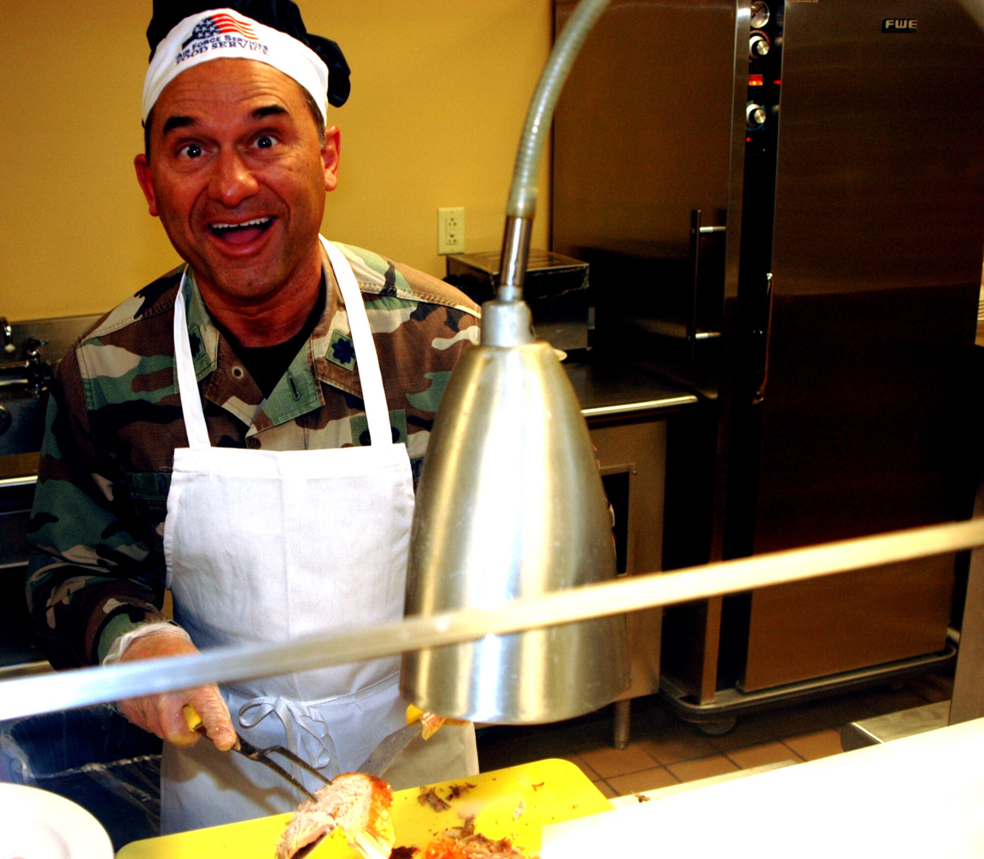 GRISSOM AIR RESERVE BASE, Ind., -- Lt. Col. Gregory DeMaio, 434th Air Refueling Wing performance planning officer, has fun carving up turkey for hungry service members during the December unit training assembly. To show appreciation and holiday cheer, the commanders, chief master sergeants and first sergeants of the wing served lunch to other unit members at the Grissom dining facility.(U.S. Air Force photo/Senior Airman Carl Berry)