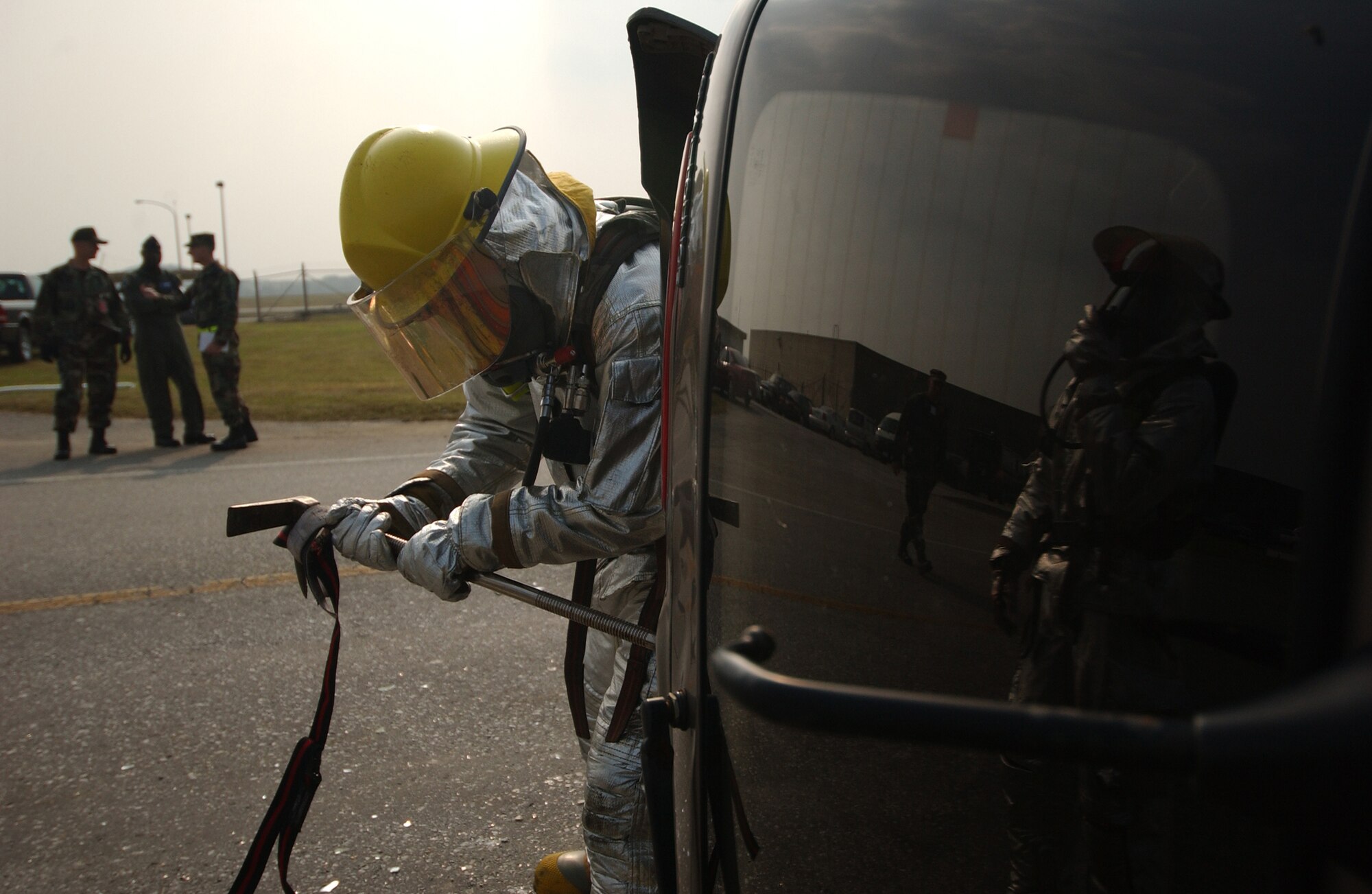 An Airman from the 18th Civil Engineer Squadron Fire Department pries open a door to gain entry and help victims injured during a simulated collision of a van with a fuel truck during Local Operational Readiness Exercise Beverly High 08-2 at Kadena Air Base, Japan, Dec. 3, 2007. These scenarios enable base agencies to work together, mitigate real-world situations, and heighten readiness capabilities.
(U.S. Air Force photo/Tech. Sgt. Rey Ramon)
