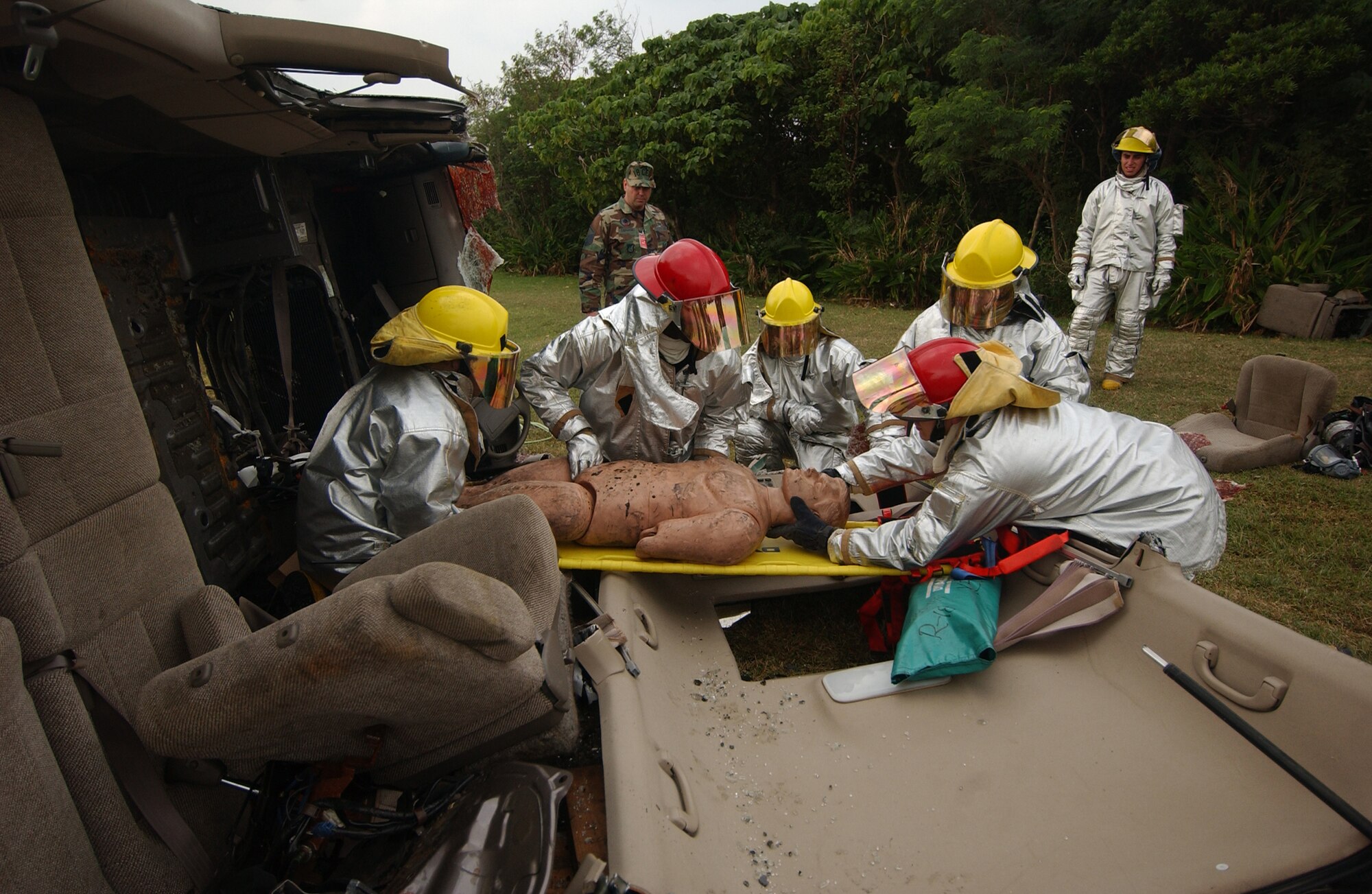 Airmen from the 18th Civil Engineer Squadron Fire Department pry open the roof of a vehicle to gain entry and help injured victims during a simulated collision of a van with a fuel truck during the Local Operational Readiness Exercise Beverly High 08-2 at Kadena Air Base, Japan, Dec. 3, 2007. These scenarios enable base agencies to work together, mitigate real-world situations, and heighten readiness capabilities.
(U.S. Air Force photo/Tech. Sgt. Rey Ramon)
