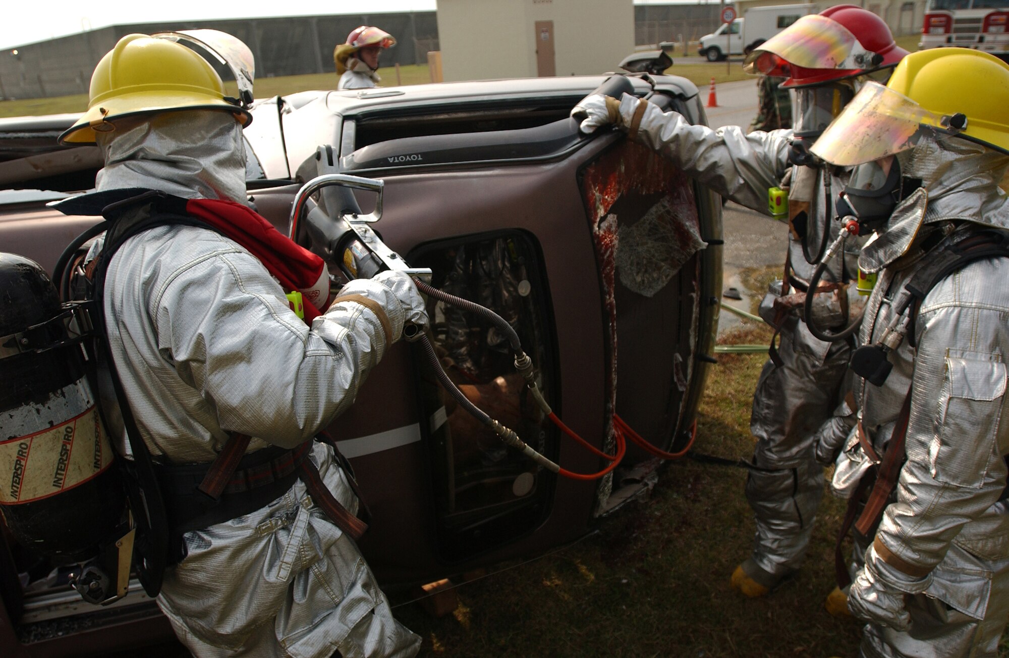 Airmen from the 18th Civil Engineer Squadron Fire Department pry open the roof of a vehicle to gain entry and help injured victims during a simulated collision of a van with a fuel truck during Local Operational Readiness Exercise Beverly High 08-2 at Kadena Air Base, Japan, Dec. 3, 2007. These scenarios enable base agencies to work together, mitigate real-world situations, and heighten readiness capabilities.
(U.S. Air Force photo/Tech. Sgt. Rey Ramon)
