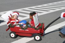 Breiann Bergman and Isabela West throw candy to the crowd during the 2007 Holiday Parade Dec. 1 at Kadena Air Base, Japan. The parade featured numerous organizations and kicked off the Tinsel Town celebration at the Schilling Community Center. 