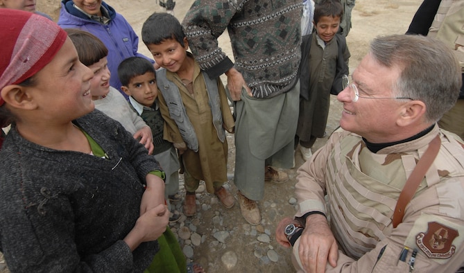 BAGRAM AIR BASE, Afghanistan - Children greet Lt. Gen. John Bradley, Dec. 3, 2007 at a village near here.  General Bradley arrived here Dec. 2 with more than 25,000 lbs. of humanitarian relief supplies collected by his wife, Jan, for distribution to local villages such as this one. (U.S. Air Force Photo by Master Sgt. Rick Sforza)(Released)