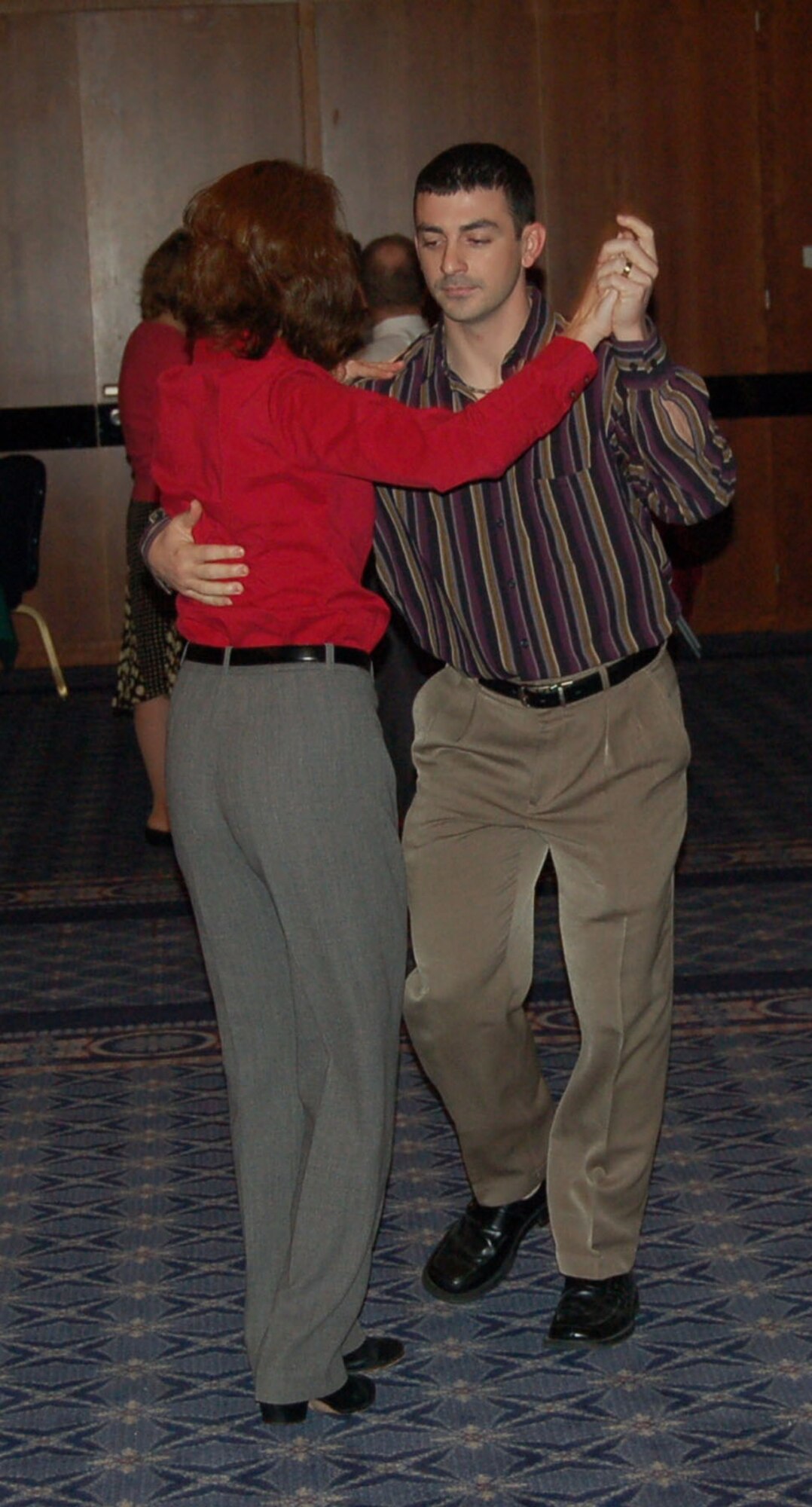 SPANGDAHLEM AIR BASE, Germany -- Senior Airman Chris Johnson, 52nd Communications Squadron, and his wife, Angie, dance during the 52nd Fighter Wing Holiday Party at Club Eifel Dec. 1, 2007. (U.S. Air Force photo/Capt. Kevin Coffman)