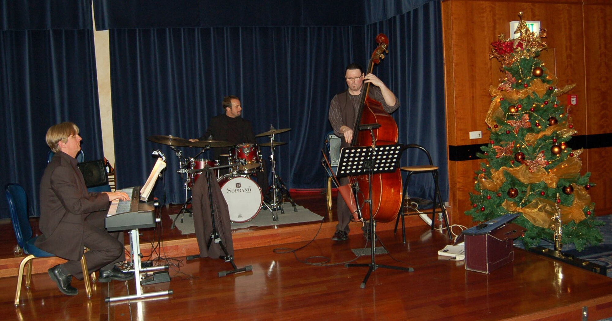 SPANGDAHLEM AIR BASE, Germany -- Senior Airman Sydney Mitchell, 52nd Medical Support Squadron, joins the F.E.B. Trio jazz band during the 52nd Fighter Wing Holiday Party at Club Eifel Dec. 1, 2007. (U.S. Air Force photo/Capt. Kevin Coffman)