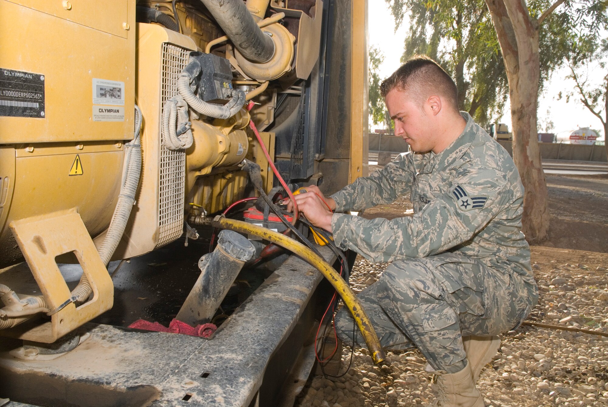 BALAD AIR BASE, Iraq -- Senior Airman Bryan Carmean, a 332nd Expeditionary Civil Engineer Squadron power production specialist, checks the voltage on a 12 volt battery after performing a maintenance check on a generator here, Dec. 3. The check ensures the direct current alternator is providing a proper charge during operation. Airman Carmean is deployed from Holloman Air Force Base, N.M. (U.S. Air Force photo/Staff Sgt. Joshua J. Garcia)  
