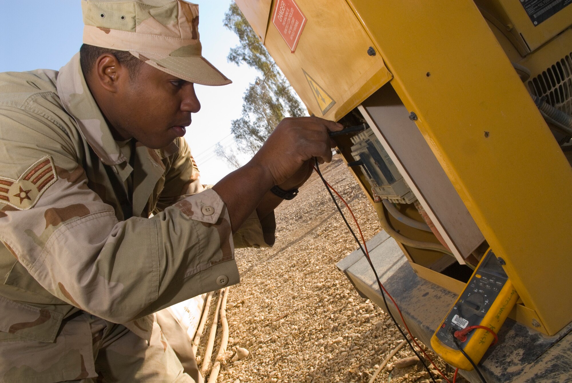 BALAD AIR BASE, Iraq -- Senior Airman Frank InNiss, a 332nd Expeditionary Civil Engineer Squadron power production journeyman, checks the voltage and frequency of a main alternating current circuit breaker on a generator here, Dec. 3. The voltage and frequency check ensures the breaker is receiving adequate and proper power. Airman InNiss is deployed from Holloman Air Force Base, N.M. (U.S. Air Force photo/Staff Sgt. Joshua J. Garcia) 