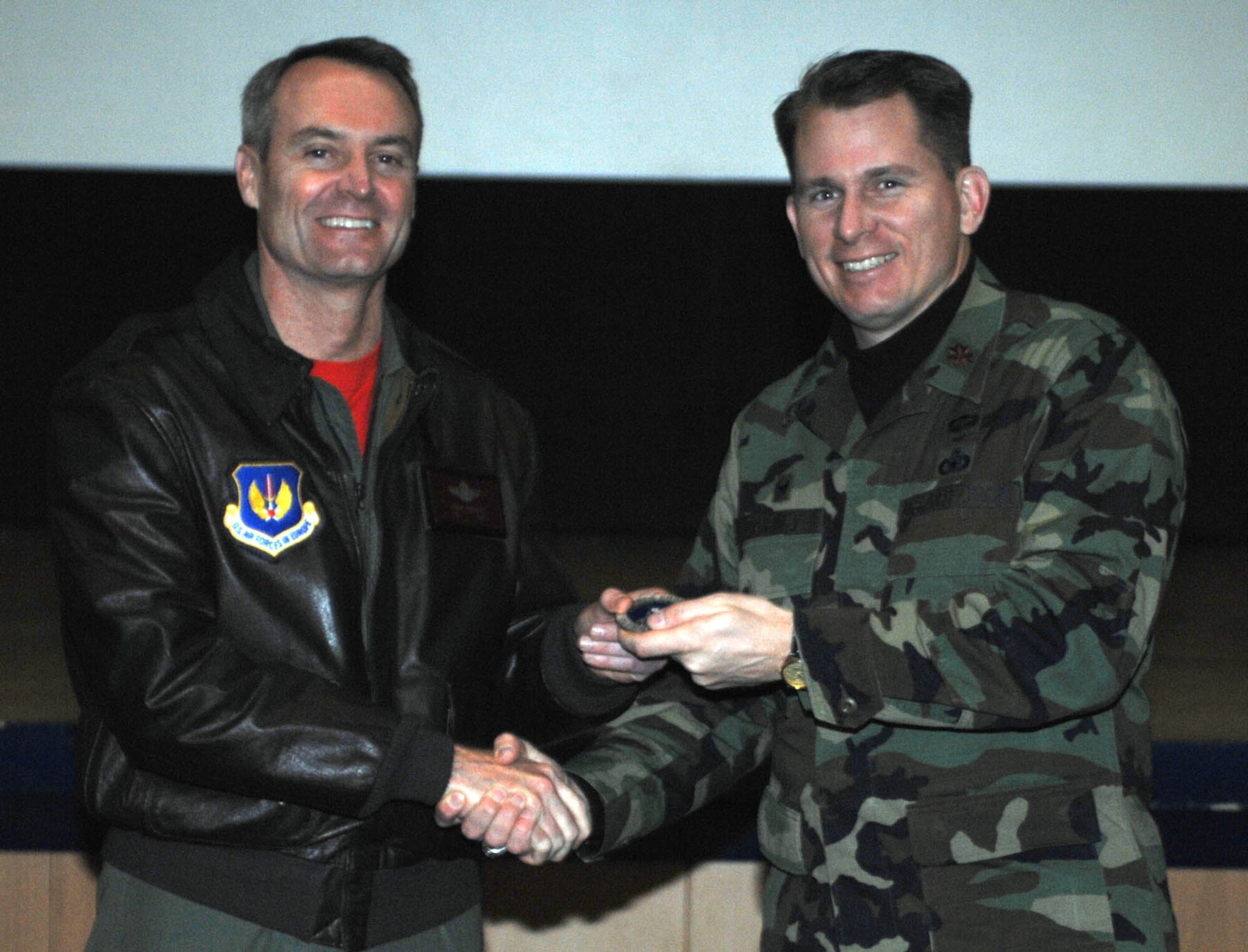 SPANGDAHLEM AIR BASE, Germany –Col. Darryl Roberson, 52nd Fighter Wing commander, returns the 52nd Security Forces Saber Choices coin to Maj. Paul Cairney, the squadron commander. The coin signifies that the unit has gone 52 days without any driving while under the influence or alcohol related incidents. (U.S. Air Force photo/Airman 1st Class Jennifer Calhoun)
