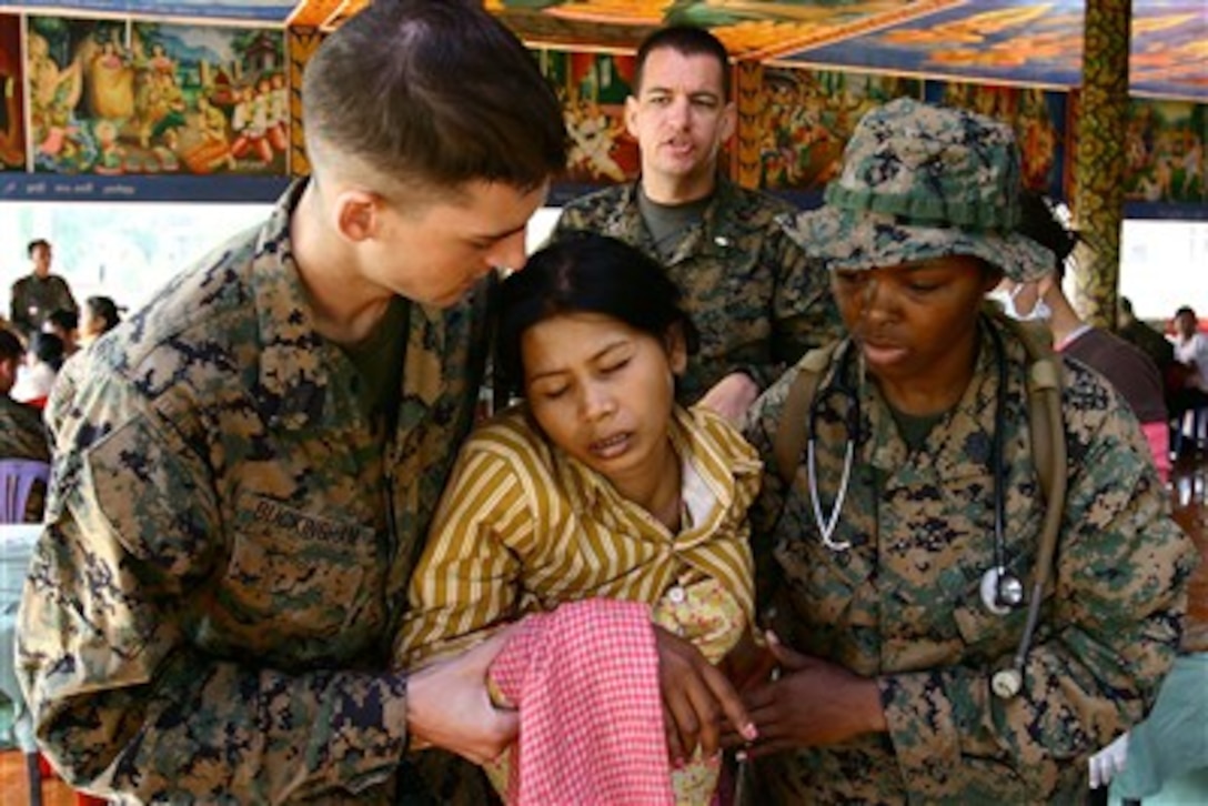A Cambodian woman is helped by U.S. Navy medical personnel at a clinic in Stung Trung village in Kampong Cham, Cambodia, on Nov. 29, 2007.  The amphibious assault ship USS Essex (LHD 2) and the 31st Marine Expeditionary Unit, Amphibious Squadron 11 are in Sihanoukville, Cambodia, to participate in community relations events, medical and dental projects and professional exchanges with the Cambodian military.  