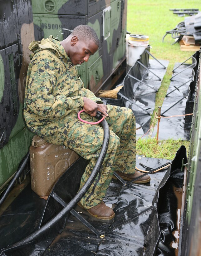Lance Cpl. Antonio Paul, electrician, support company, Combat Service Support Group-3, installs generators that will power the communications systems for the Command Operation Center during exercise Thunderdome 2007, Dec. 5.