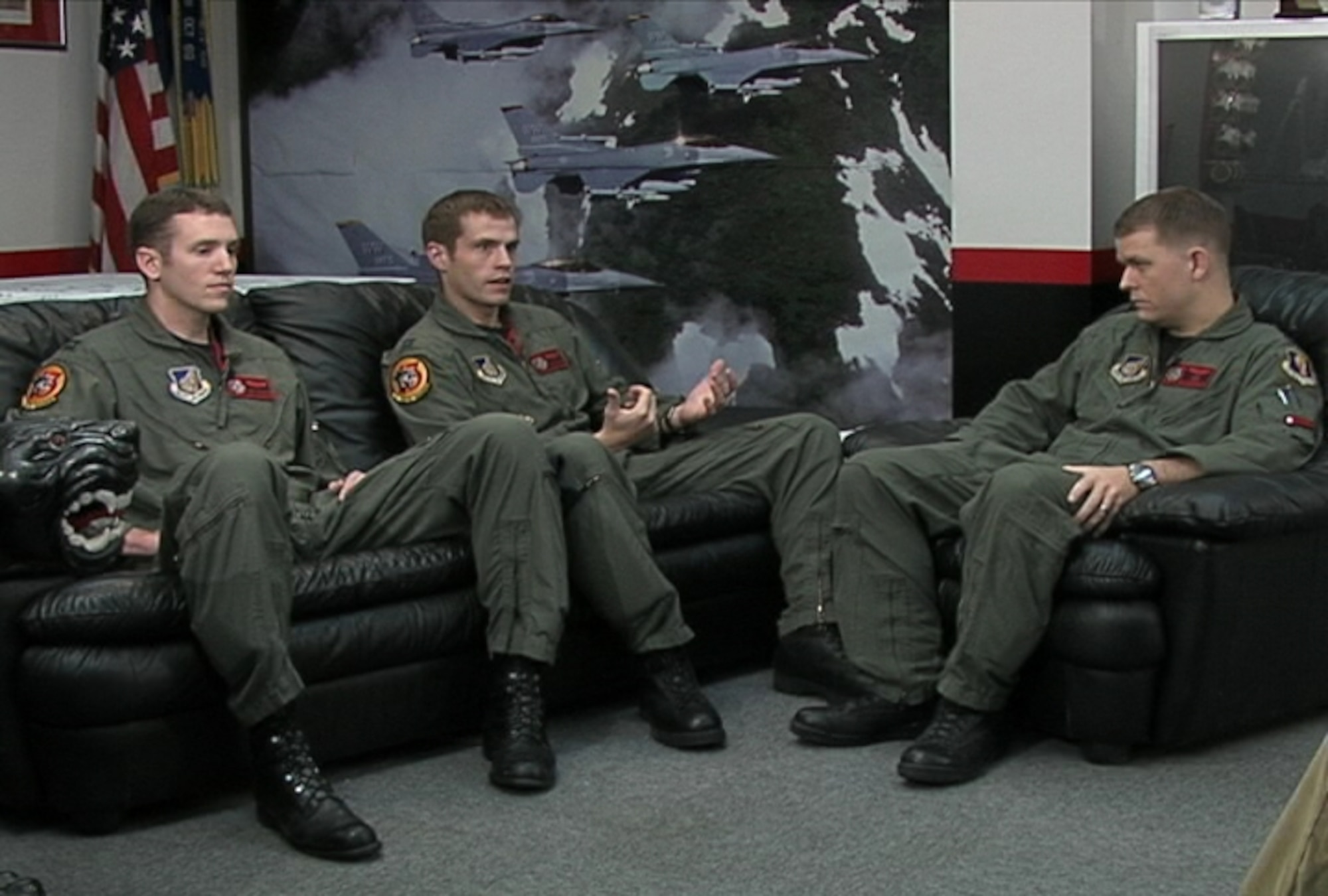 MISAWA AIR BASE, Japan -- From left to right, Captains Alex Wolfard, Kevin Hicok and Eric Freienmuth, pilots with the 13th Fighter Squadron, sit down in the squadron's Panther History Room and share stories from their recent deployment to Iraq. (U.S. Air Force photo)