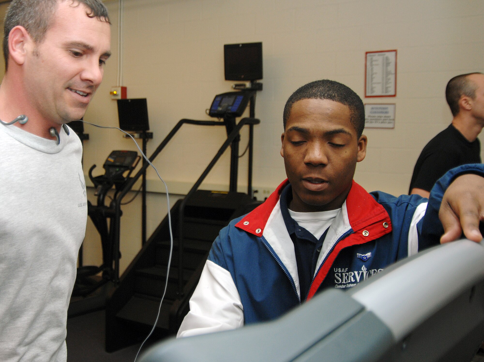 MOUNTAIN HOME AIR FORCE BASE, Idaho -- Airman 1st Class Aaron Morrow (right) instructs a fitness center patron on the proper use of a treadmill. Airman Morrow serves as a fitness center apprentice with the 366th Services Squadron. (U.S. Air Force photo/ Airman 1st Class Ryan Crane) 