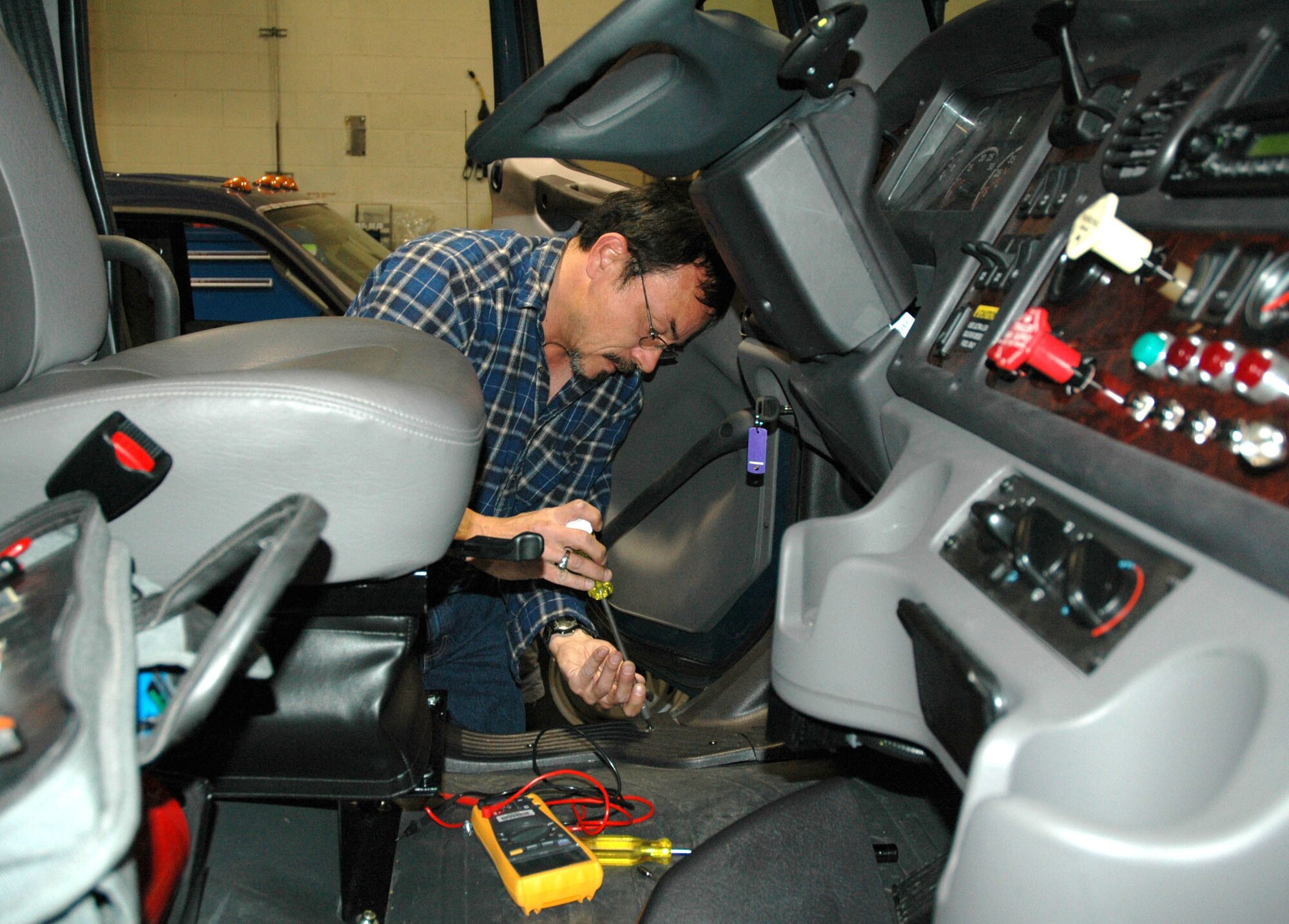 Craig Davis, 341st Communications Squadron radio maintenance technician, installs a mobile radio in a semi-truck Nov. 26. The radio maintenance shop is one of the 15 work centers who contributed to the zero safety discrepancies from July 2006 to July 2007. Their combined efforts earned the Akima Corporation President's Safety Award for 2007. (U.S. Air Force photo/Senior Airman Eydie Sakura).