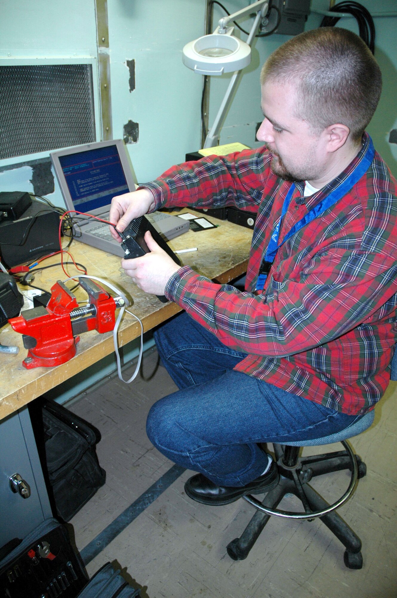 Kai Jendersen, 341st Communications Squadron base radio technician, removes military channels off old radios before sending them to the Defense Reutilization Marketing Office Nov. 26. The radio maintenance shops is one of the 15 work centers who contributed to the zero safety discrepancies from July 2006 to July 2007. Their combined efforts earned the Akima Corporation President's Safety Award for 2007. (U.S. Air Force photo/Senior Airman Eydie Sakura).