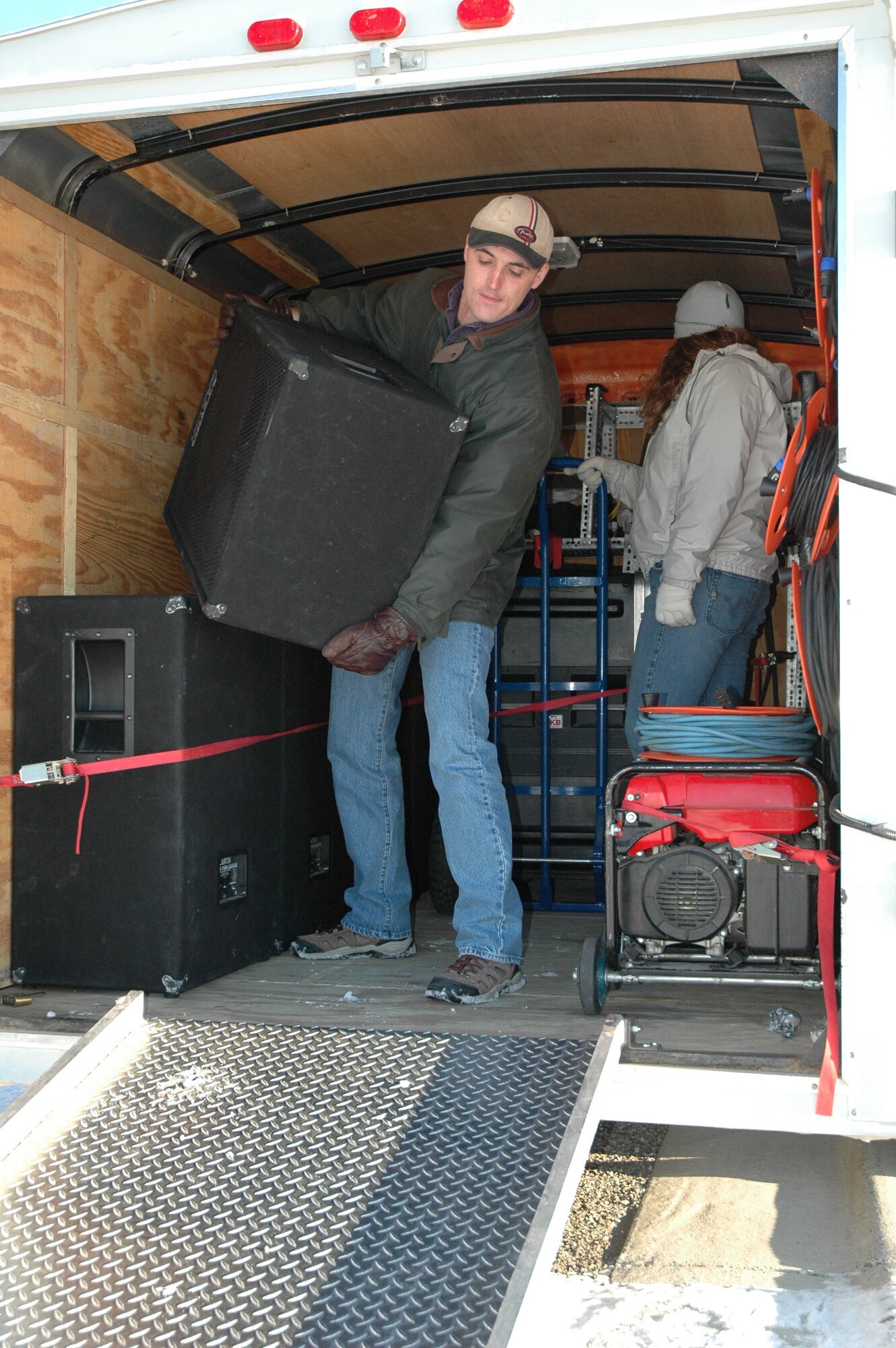 John Turner, 341st Communications Squadron photographer, unloads public address equipment used for ceremonies and events from a trailer on a snowy winter day Nov. 26. The multi-media shop is one of the 15 work centers who contributed to the zero safety discrepancies from July 2006 to July 2007. Their combined efforts earned the Akima Corporation President's Safety Award for 2007. (U.S. Air Force photo/Senior Airman Eydie Sakura).
