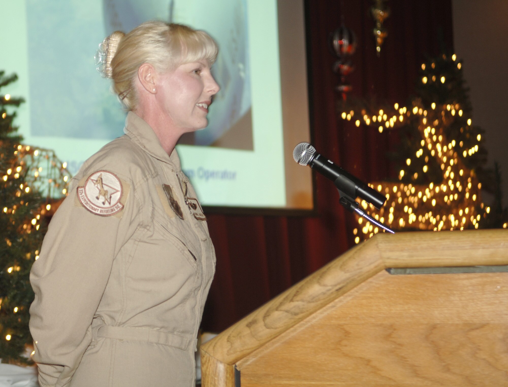 FAIRCHILD AIR FORCE BASE, Wash. -- Master Sgt. Hildie Frazier, 92nd Air Refueling Squadron boom operator, relates her deployment experiences to the audience during the 92nd Air Refueling Wing’s Holiday Party at Club Fairchild on Dec. 2. (U.S. Air Force photo / Senior Airman Chad Watkins)