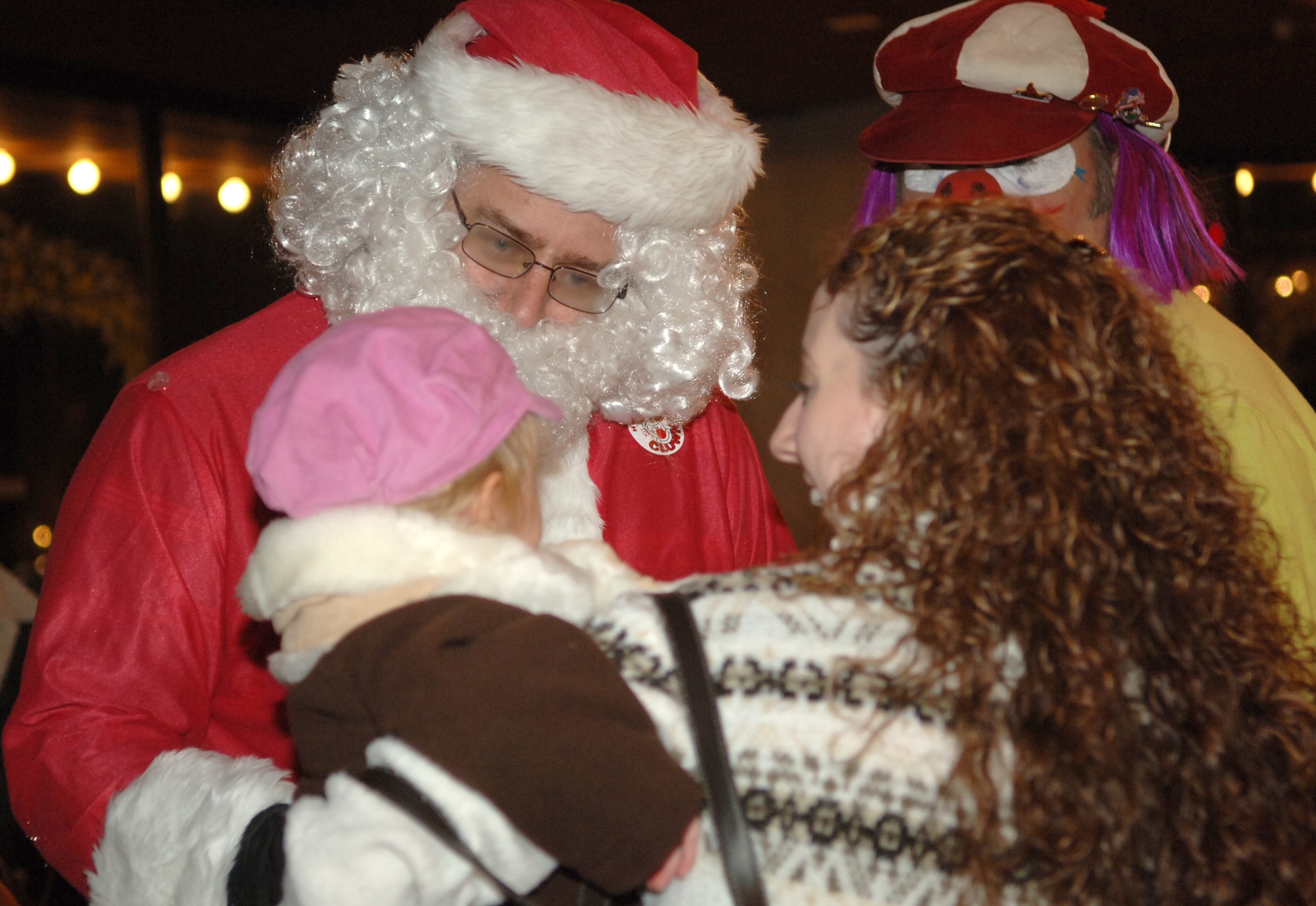FAIRCHILD AIR FORCE BASE, Wash. – Santa Claus visits with 21-month-old MacKenzie Pogreba, and her mother, Stephanie Pogreba, during the Operations Spokane Heroes holiday party at the carrousel in Riverfront Park, downtown Spokane on Nov. 30. OSH hosted the holiday party for local families of deployed military members. The families were able to visit with Santa, ride the carrousel and enjoy pizza as part of the festivities. (U.S. Air Force photo by Airman 1st Class Jocelyn A. Ford)