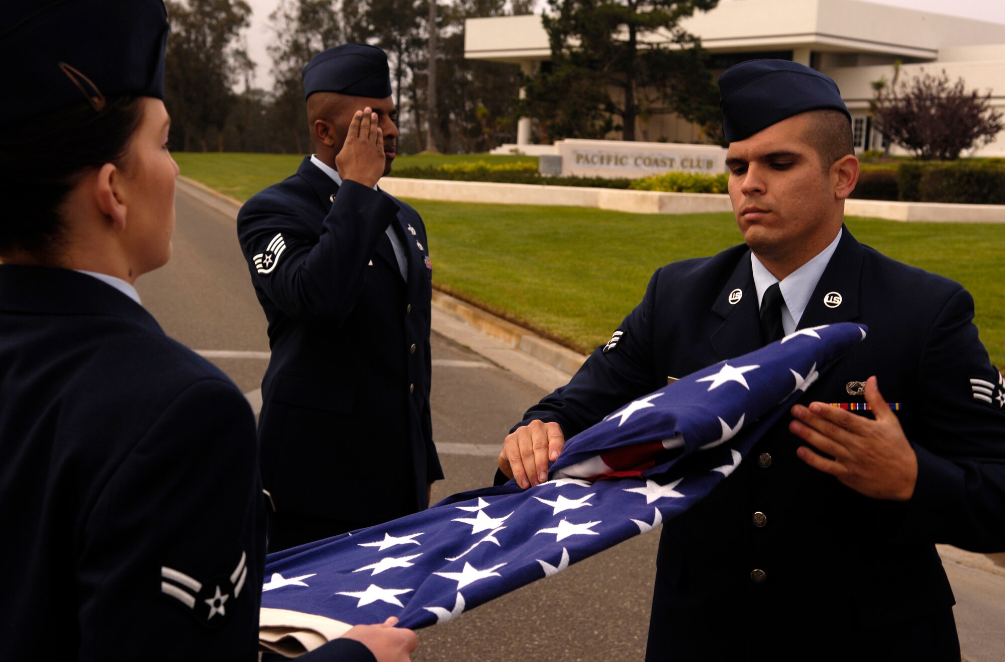 VANDENBERG AIR FORCE BASE, Calif. -- Senior Airman Rinaldo Soloranzo, an auto body repairman with the 30th Logistics Readiness Squadron, performs a flag folding ceremony during a retreat ceremony at the headquarters building on Oct. 25. 30th Mission Support Group Airmen supported the time honored open ranks inspection. Air Force Instruction 36-2903 directs the wear of uniforms, insignias, awards and decorations. Airmen of all ranks are required to have all uniform items ready to wear at any time. (U.S. Air Force photo/Airman 1st Class Christian Thomas) 
