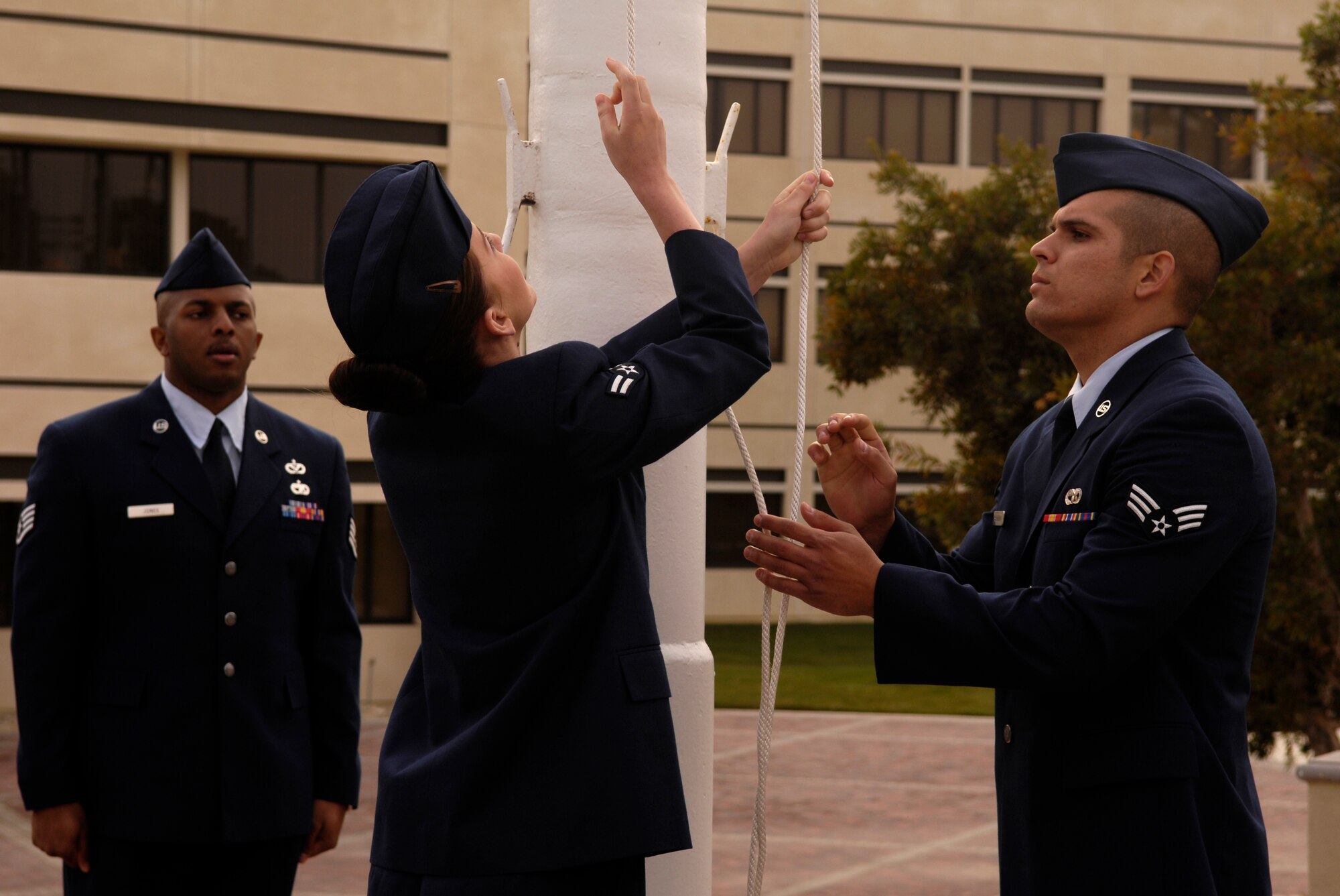 VANDENBERG AIR FORCE BASE, Calif. -- Airmen lower the flag during a retreat ceremony at the headquarters building on Oct. 25. 30th Mission Support Group Airmen supported the time honored open ranks inspection. Air Force Instruction 36-2903 directs the wear of uniforms, insignias, awards and decorations. Airmen of all ranks are required to have all uniform items ready to wear at any time. (U.S. Air Force photo/Airman 1st Class Christian Thomas) 

