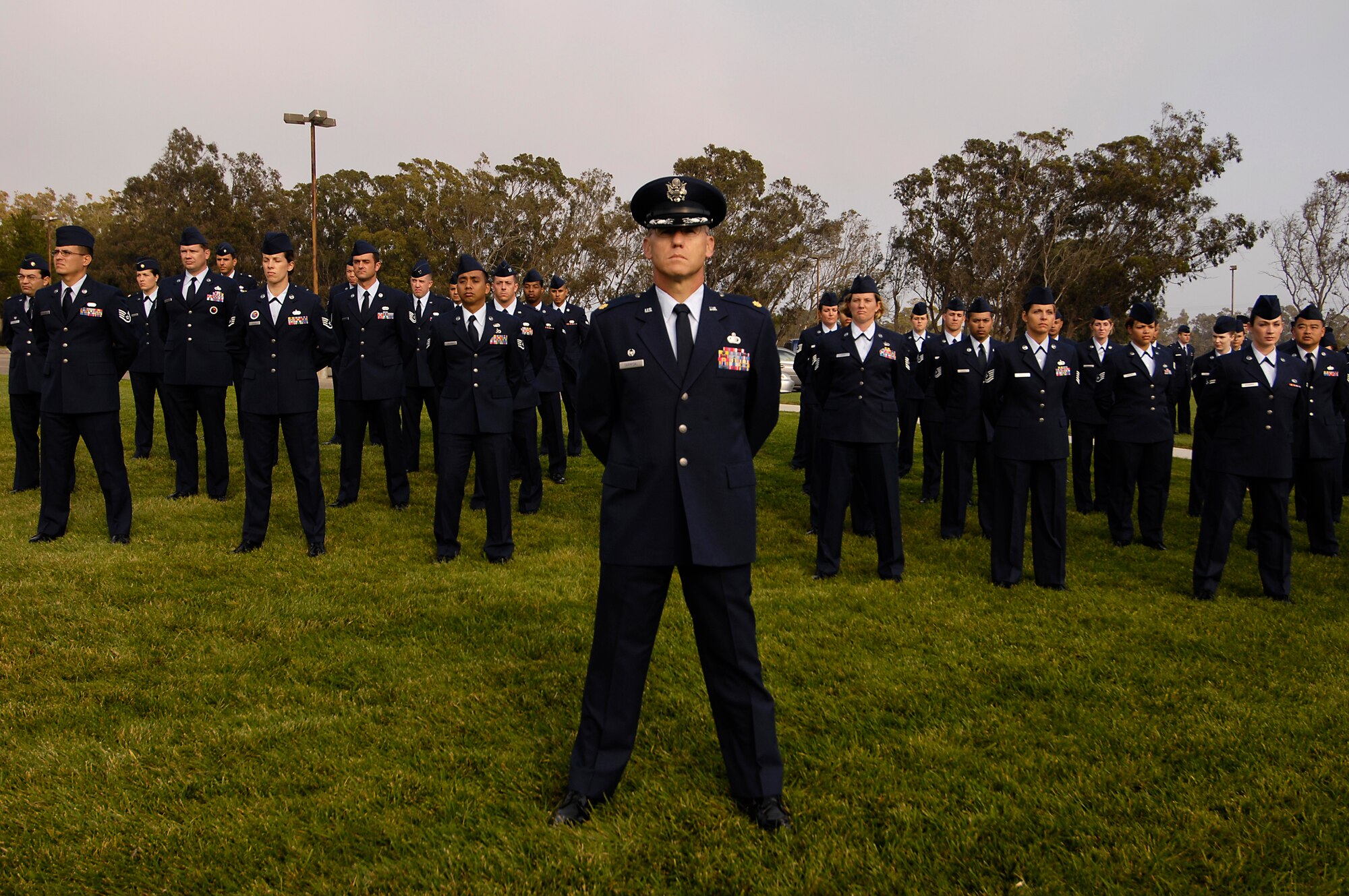 VANDENBERG AIR FORCE BASE, Calif. --  Maj. William Archer and Airmen stand at parade rest during a retreat ceremony at the headquarters building on Oct. 25.  Maj. Archer is a operations officer with the 30th Logistics Readiness Squadron. 30th Mission Support Group Airmen supported the time honored open ranks inspection. Air Force Instruction 36-2903 directs the wear of uniforms, insignias, awards and decorations. Airmen of all ranks are required to have all uniform items ready to wear at any time. (U.S. Air Force photo/Airman 1st Class Christian Thomas)