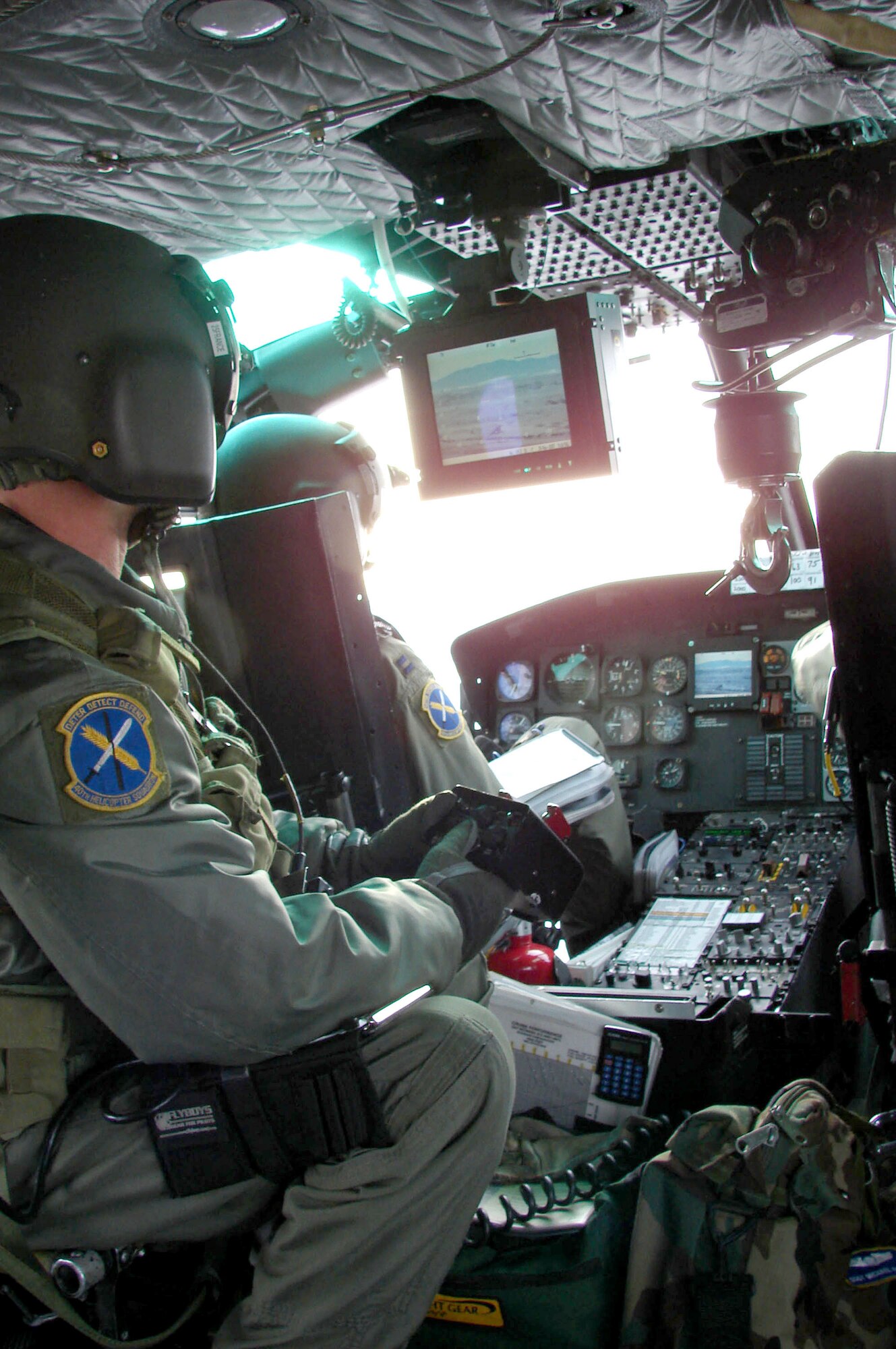 Staff Sgt. Michael Frances, 40th Helicopter Squadron flight engineer, employs the forward-looking infrared radar, a small screen that hangs from the roof of the helicopter Nov. 19. The FLIR is used to scan various convoy routes and launch facility sites. It can also be used in infrared mode to pick up heat sources such as a body of a lost hiker during search and rescue operations. (U.S. Air Force photo/Senior Airman Eydie Sakura).