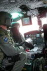 Staff Sgt. Michael Frances, 40th Helicopter Squadron flight engineer, employs the forward-looking infrared radar, a small screen that hangs from the roof of the helicopter Nov. 19. The FLIR is used to scan various convoy routes and launch facility sites. It can also be used in infrared mode to pick up heat sources such as a body of a lost hiker during search and rescue operations. (U.S. Air Force photo/Senior Airman Eydie Sakura).