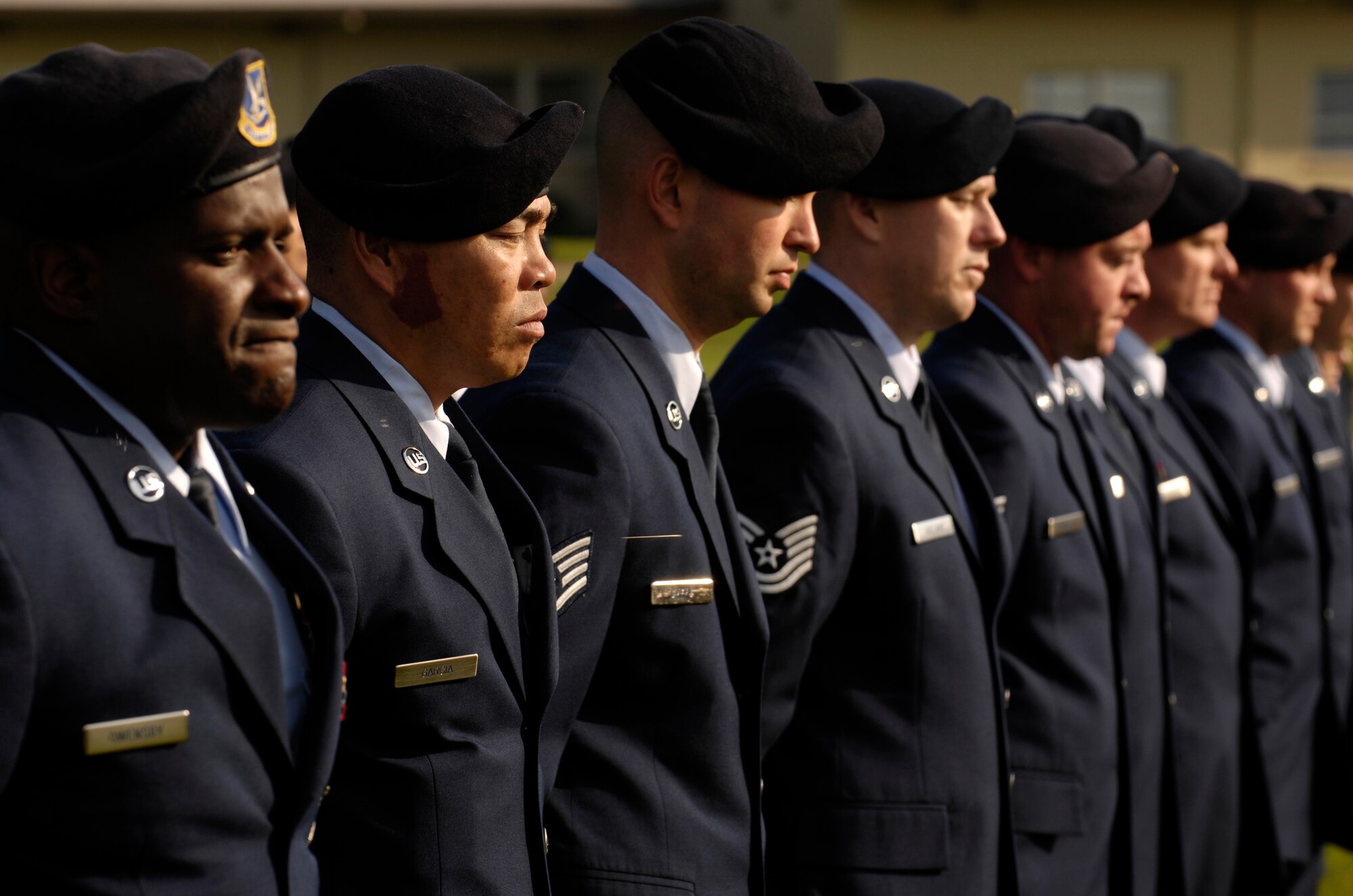 VANDENBERG AIR FORCE BASE, Calif. -- Airmen from the 30th Security Forces Squadron stand at parade rest during a retreat ceremony at the headquarters building on Oct. 25. 30th Mission Support Group Airmen supported the time honored open ranks inspection. Air Force Instruction 36-2903 directs the wear of uniforms, insignias, awards and decorations. Airmen of all ranks are required to have all uniform items ready to wear at any time. (U.S. Air Force photo/Airman 1st Class Christian Thomas) 
