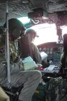 Capt. Graydon Muller, 40th Helicopter Squadron pilot, and Staff Sgt. Michael Frances, 40th HS flight engineer, go over checklists during a training sortie Nov. 19. (U.S. Air Force photo/Senior Airman Eydie Sakura).