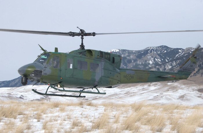 A UH-1N Huey helicopter from the 40th Helicopter Squadron hovers over the Montana skyline near the Rocky Mountain Front during a search and rescue training sortie Nov. 19. (U.S. Air Force photo/Senior Airman Eydie Sakura).                     