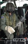 Staff Sgt. Michael Frances, 40th Helicopter Squadron flight engineer, hooks up a stokes litter, a stretcher designed to transport people from the ground to the helicopter while in the air, during a search and rescue training sortie Nov. 19. The stokes litter has multiple attach points, separate hold-down cables and powered extension hoists to help save more lives. (U.S. Air Force photo/Senior Airman Eydie Sakura).