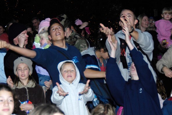 HANSCOM AFB, Mass. – Base youth eagerly catch the sweet treats tossed by Santa preceding the base tree lighting ceremony Nov. 29 near the Base Chapel. (U.S. Air Force photo by Linda LaBonte Britt)