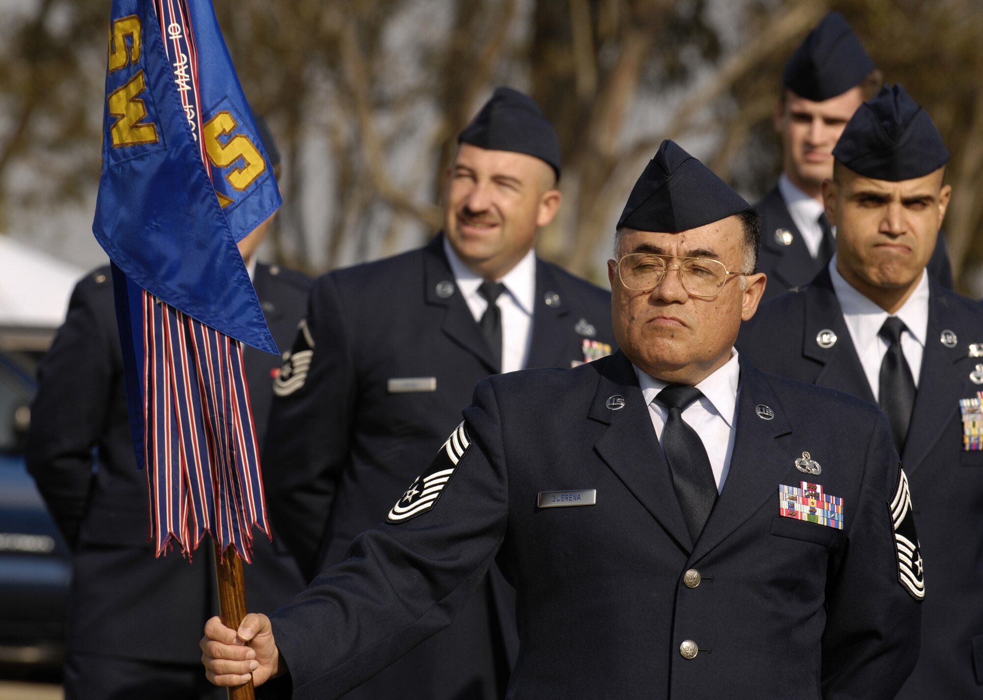 VANDENBERG AIR FORCE BASE, Calif. -- Chief Master Sgt. Ernest Guerena, a superintendent with the 30th Logistics Readiness Squadron, holds the squadron guide-on during a retreat ceremony at the headquarters building on Oct. 25. 30th Mission Support Group Airmen supported the time honored open ranks inspection. Air Force Instruction 36-2903 directs the wear of uniforms, insignias, awards and decorations. Airmen of all ranks are required to have all uniform items ready to wear at any time. (U.S. Air Force photo/Airman 1st Class Christian Thomas) 
