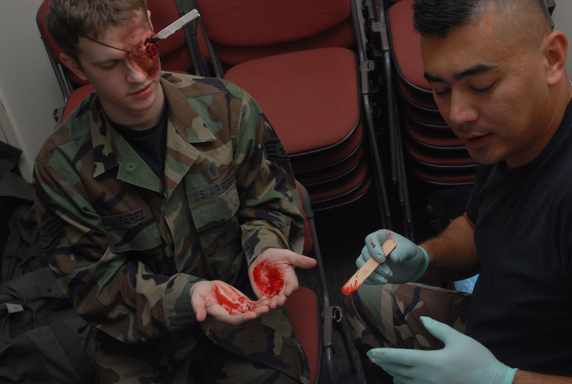 Tech. Sgt. Jay McLaren, an Exercise Evaluation Team member from the 18th Dental Squadron, applies moulage to Airman 1st Class Michael Henseler, a role player from the 18th DS, during Local Operational Readiness Exercise Beverly High 08-2 at Kadena Air Base, Japan, Dec. 4, 2007. Role players are often moulaged in order to add realism to exercise scenarios. These scenarios enable base agencies to work together, mitigate real-world situations, and heighten readiness capabilities. (U.S. Air Force photo/Staff Sgt. Christopher A. Marasky)