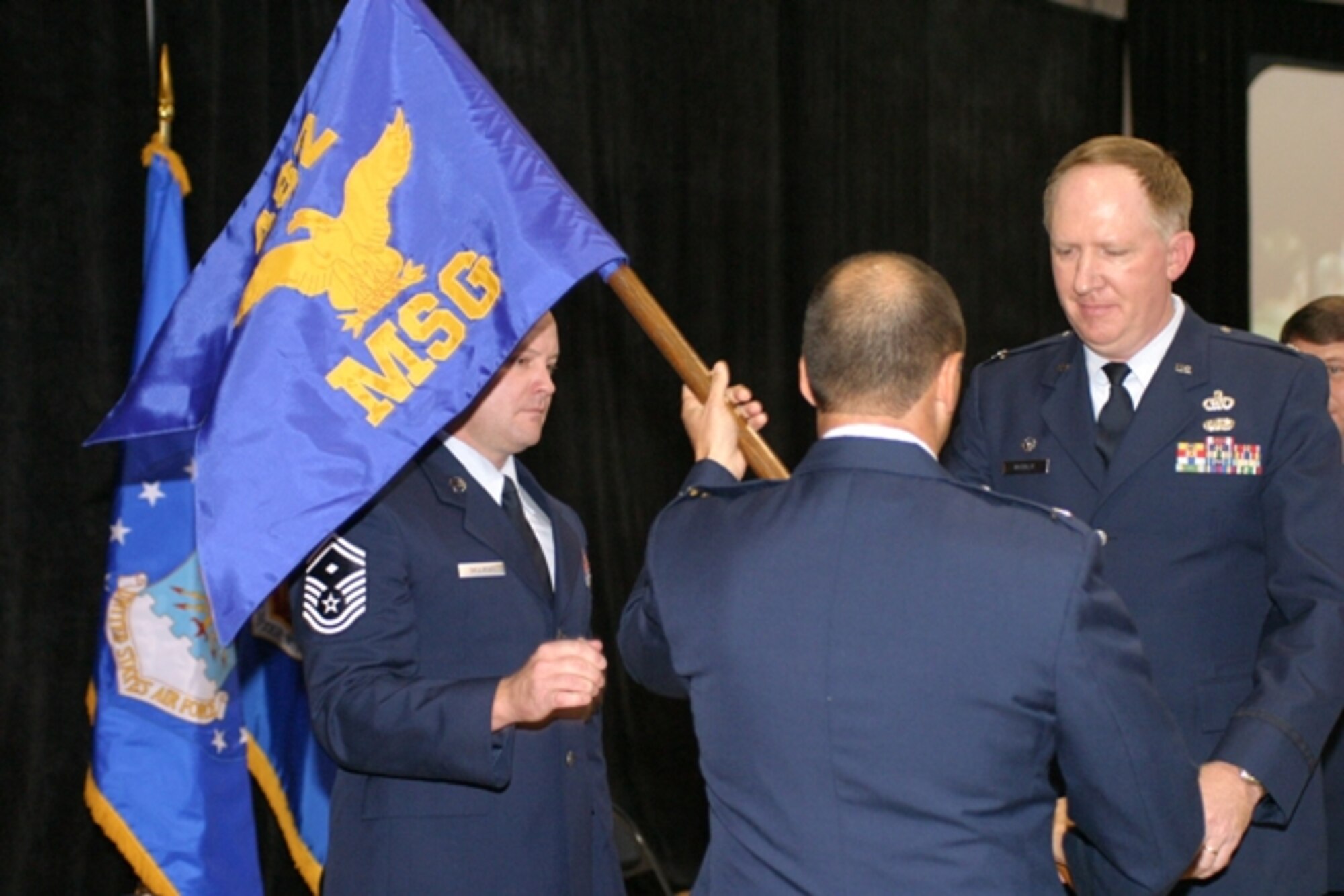 Col. Michael McCully (right) accepts the guidon and command of the 482nd Mission Support Group from Col. Randall Falcon, 482nd Fighter Wing commander in an assumption of command ceremony in front of hundreds of reservists Dec. 1. Colonel McCully replaces Colonel Daley, who commanded the group since May 2002. (U.S. Air Force Photo/Tech. Sgt. Paul Dean)