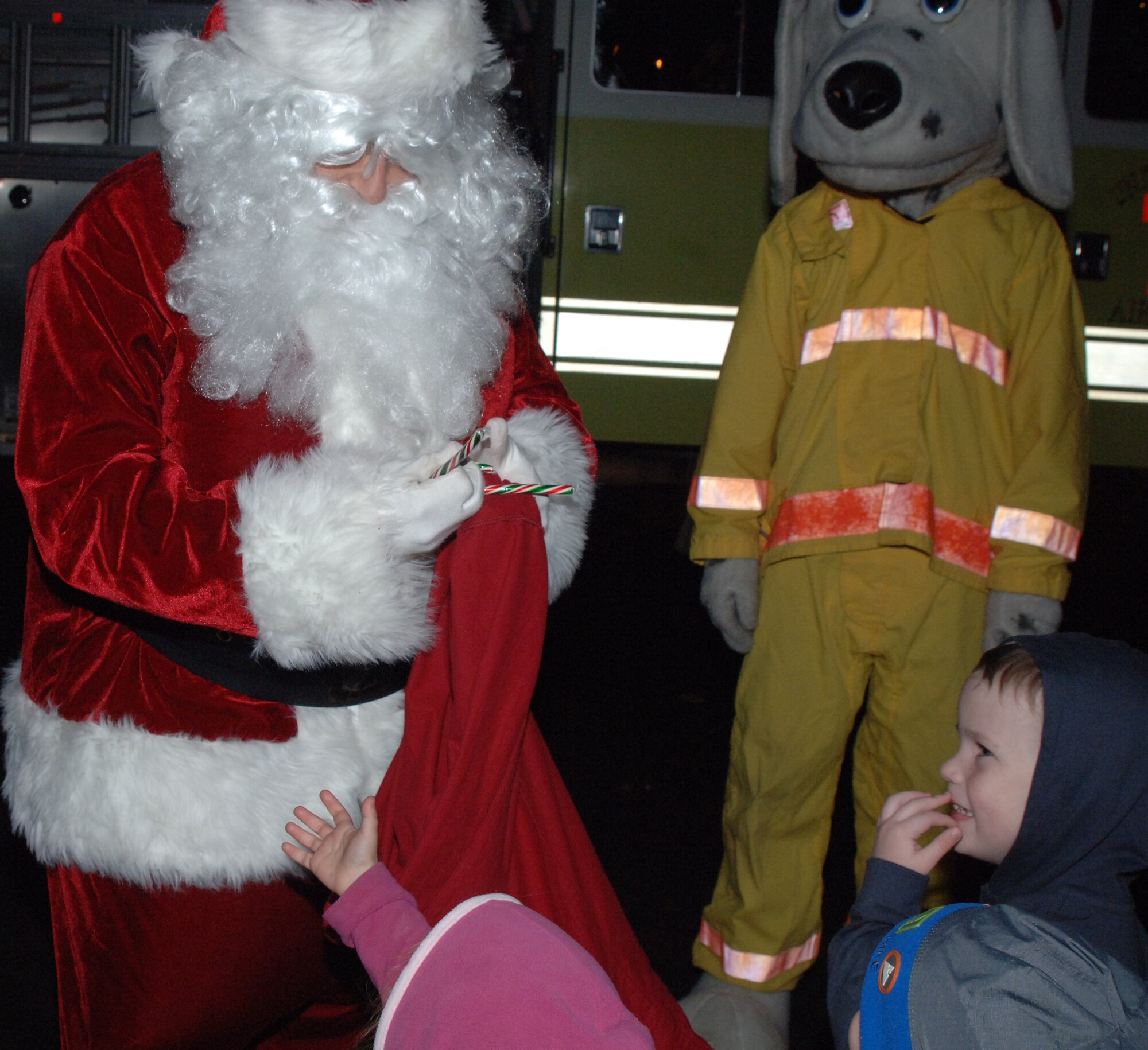 Santa Clause handed out candy canes at the tree lighting ceremony Monday. BLAZE Team members gathered to witness the lighting, sing Christmas carols and visit with Santa Clause at the ceremony. Youth were then invited to visit with Santa Clause at the Chapel Annex. (U.S. Air Force photo by Airman 1st Class Danielle Powell)