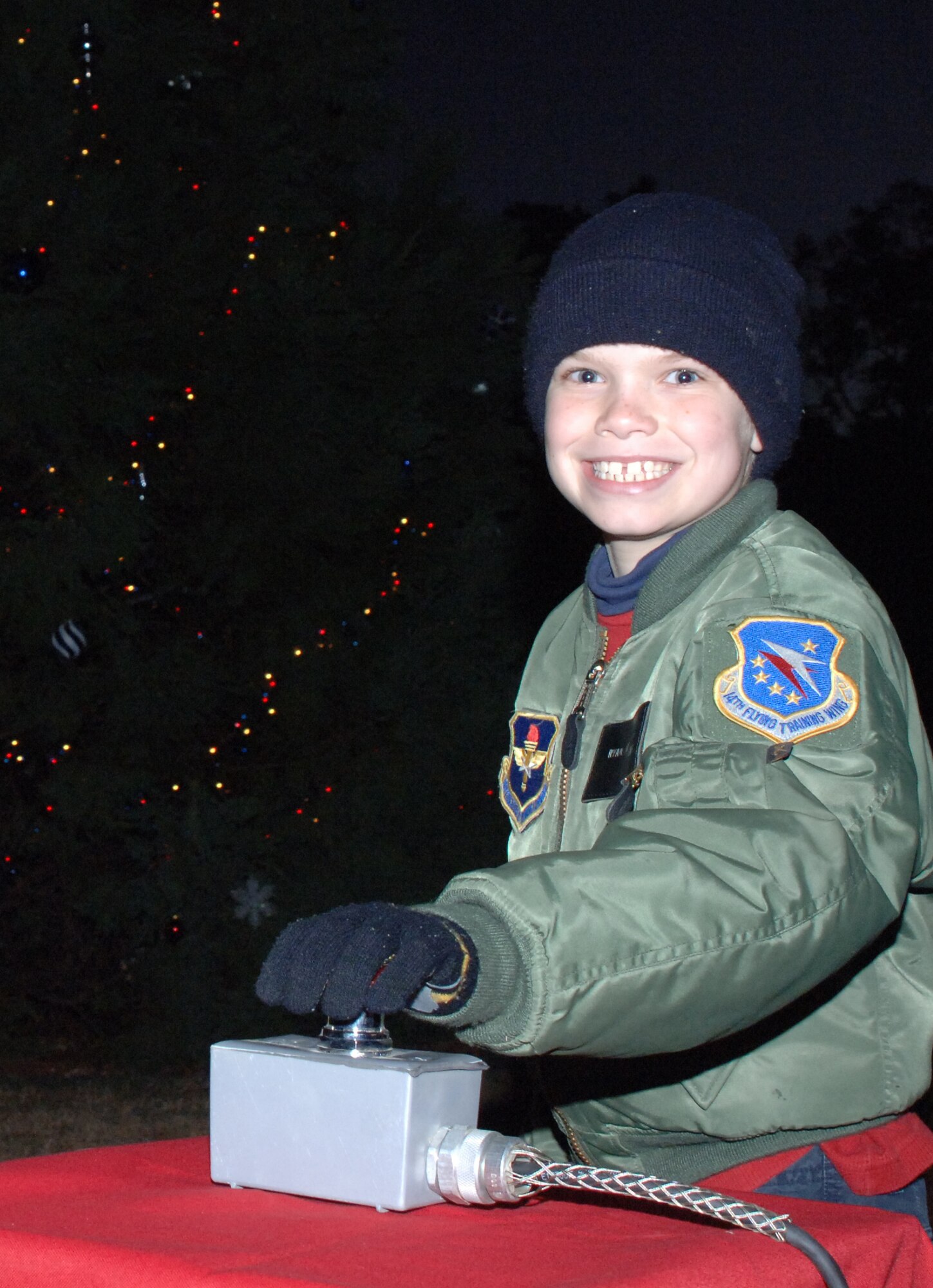Ryan McCalip, son of Maj. Randy McCalip, 14th Medical Operations Squadron, was selected to hit the switch at the tree lighting ceremony Monday evening. BLAZE Team members gathered to witness the lighting, sing Christmas carols and visit with Santa Clause at the ceremony. Youth were then invited to visit with Santa Clause at the Chapel Annex. (U.S. Air Force photo by Airman 1st Class Danielle Powell)