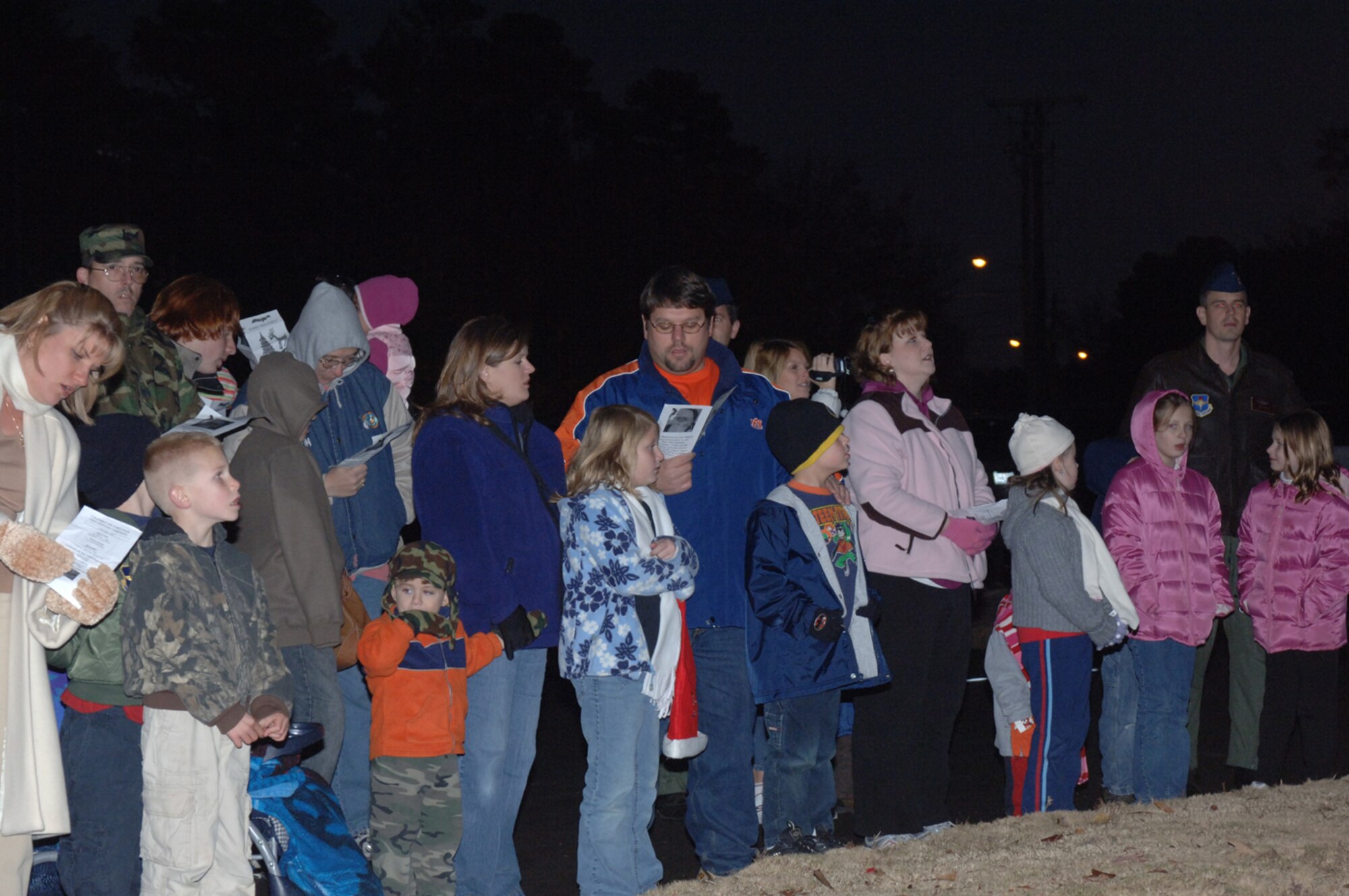 BLAZE Team members gathered Monday evening to sing Christmas carols at the tree lighting ceremony. Youth were then invited to visit with Santa Clause at the Chapel Annex. (U.S. Air Force photo by Airman 1st Class Danielle Powell)