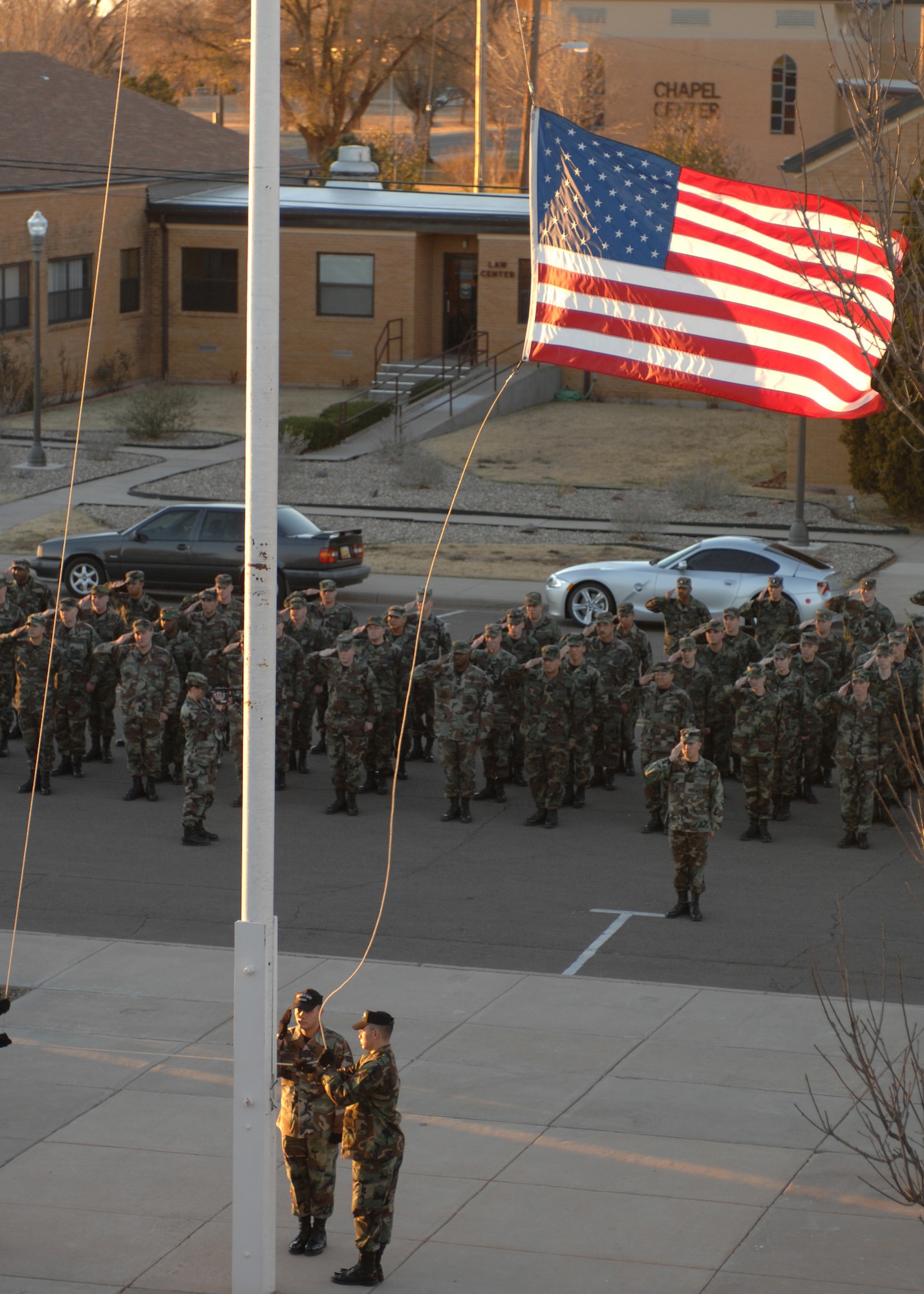CANNON AIR FORCE BASE, N.M. - Airmen from the 27th Special Operations Civil Engineering Squadron, salute the flag during a special retreat in memory of Capt. Kermit Evans, former flight commander of the 27th SOCES EOD flight, Dec. 3. The memorial dedication took place on the one-year anniversary of Capt. Evans' death in Iraq. (U.S. Air Force photo by Airman 1st Class Evelyn Chavez)