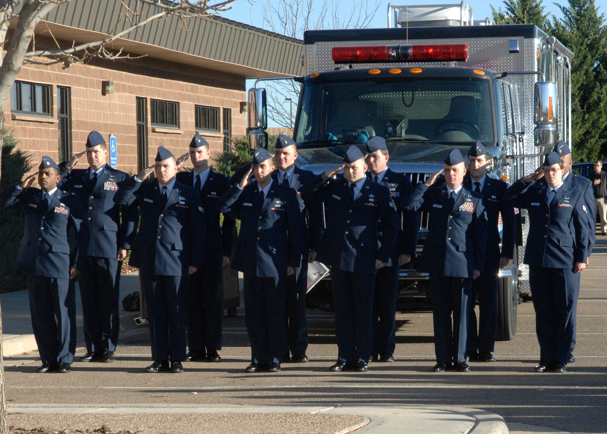 CANNON AIR FORCE BASE, N.M. - Members of the explosive ordinance disposal flight salute during the national anthem during the memorial dedication to Capt. Kermit Evans, former flight commander of the 27th Special Operations Civil Engineering Squadron's EOD flight, Dec. 3. The memorial dedication took place on the one-year anniversary of Capt. Evans' death in Iraq. (U.S. Air Force photo by Airman 1st Class Erik Cardenas)