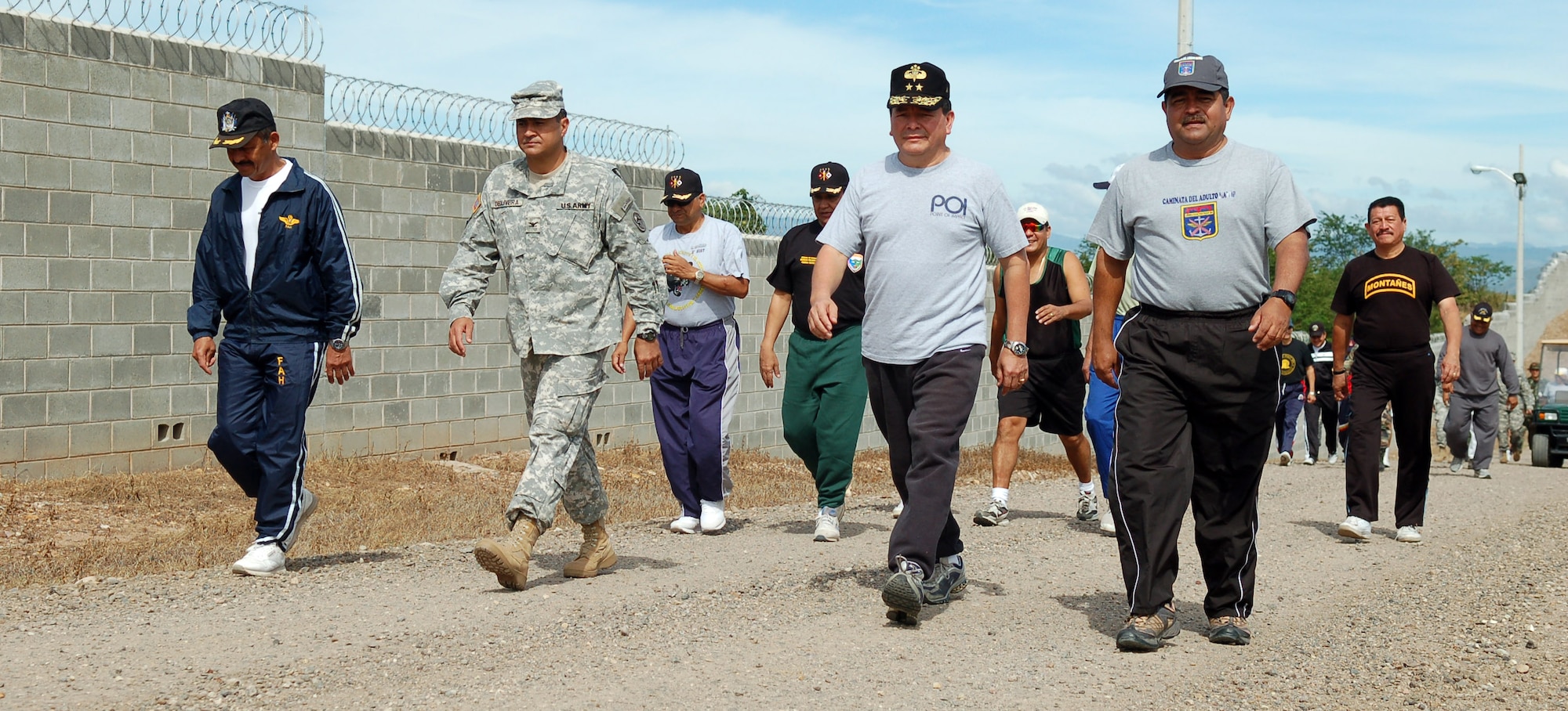 SOTO CANO AIR BASE, Honduras – Army Col. Marcus De Oliveira, Joint Task Force-Bravo commander, leads a procession of top military leaders from Honduras and JTF-Bravo Nov. 30 in a Caminata de Coroneles, a “camaraderie walk” in recognition of 39 retiring Honduran colonels.  (U.S. Air Force photo by Staff Sgt. Austin M. May)