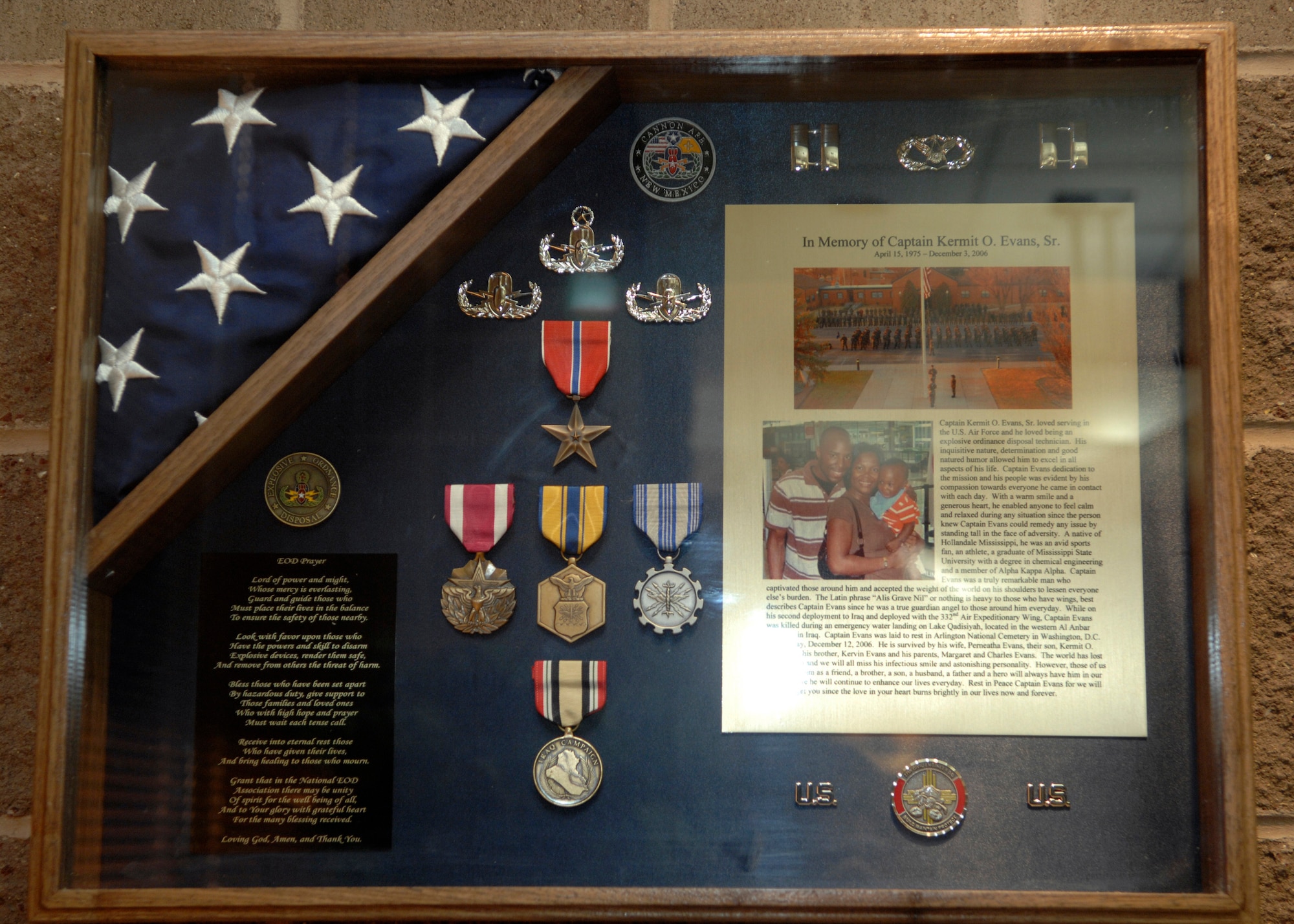 CANNON AIR FORCE BASE, N.M. - The shadow box dedicated to the life of Capt. Kermit Evans, former flight commander of the 27th Special Operations Civil Engineering Squadron's EOD flight, is displayed at the 27th SOCES during the memorial dedication Dec. 3. The memorial dedication took place on the one-year anniversary of Capt. Evans' death in Iraq. (U.S. Air Force photo by Airman 1st Class Erik Cardenas)