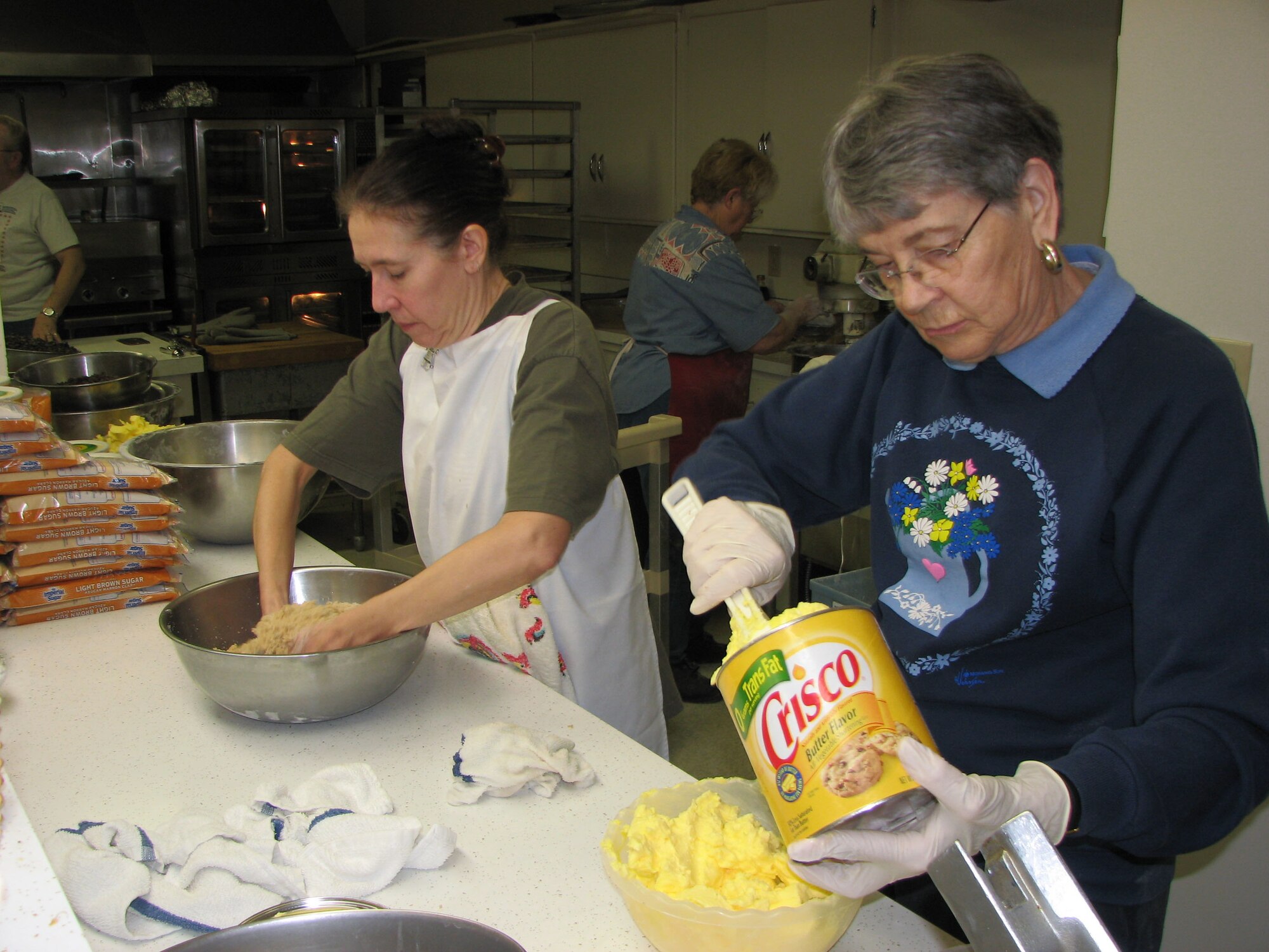MaryAnne Mackall and Vivian Peterson prepare ingredients for chocolate chip cookies at the VFW Post 1087 in Great Falls Nov. 27. The cookies were sent to deployed servicemembers from Montana Dec. 1. (U.S. Air Force photo/Airman 1st Class Dillon White)