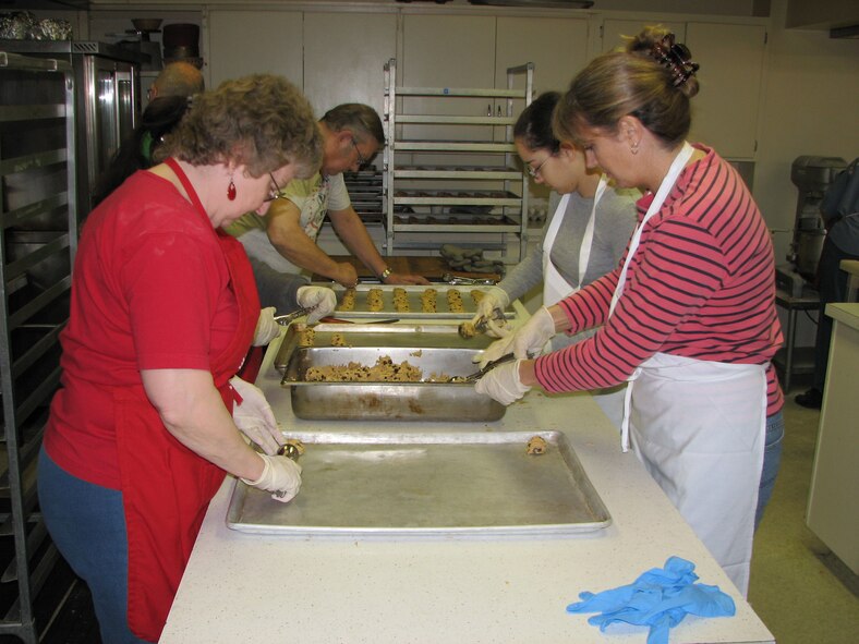 Volunteers prepare chocolate chip cookies to be placed in the oven at VFW Post 1087 Nov. 27. The cookies were sent in care packages to deployed servicemembers from Montana Dec. 1. (U.S. Air Force photo/Airman 1st Class Dillon White)