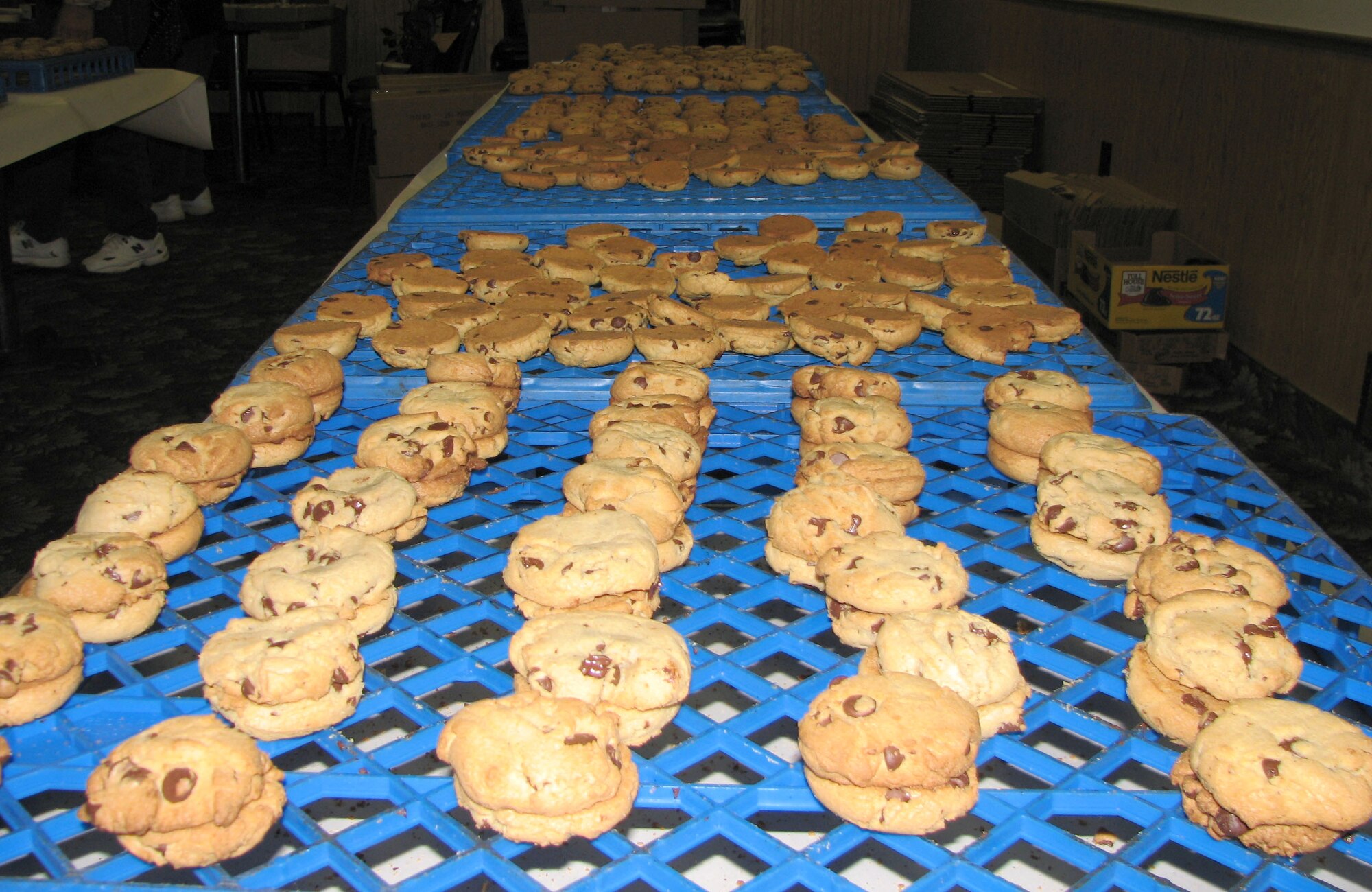 Chocolate chip cookies cool on racks prior to wrapping at the VFW Post 1087 Nov. 27. Two-thousand-five-hundred-and-sixty dozen chocolate chip, oatmeal raisin and snickerdoodle cookies were baked over the course of one week to be added to roughly 400 care packages sent to deployed servicemembers from Montana. (U.S. Air Force photo/Airman 1st Class Dillon White)