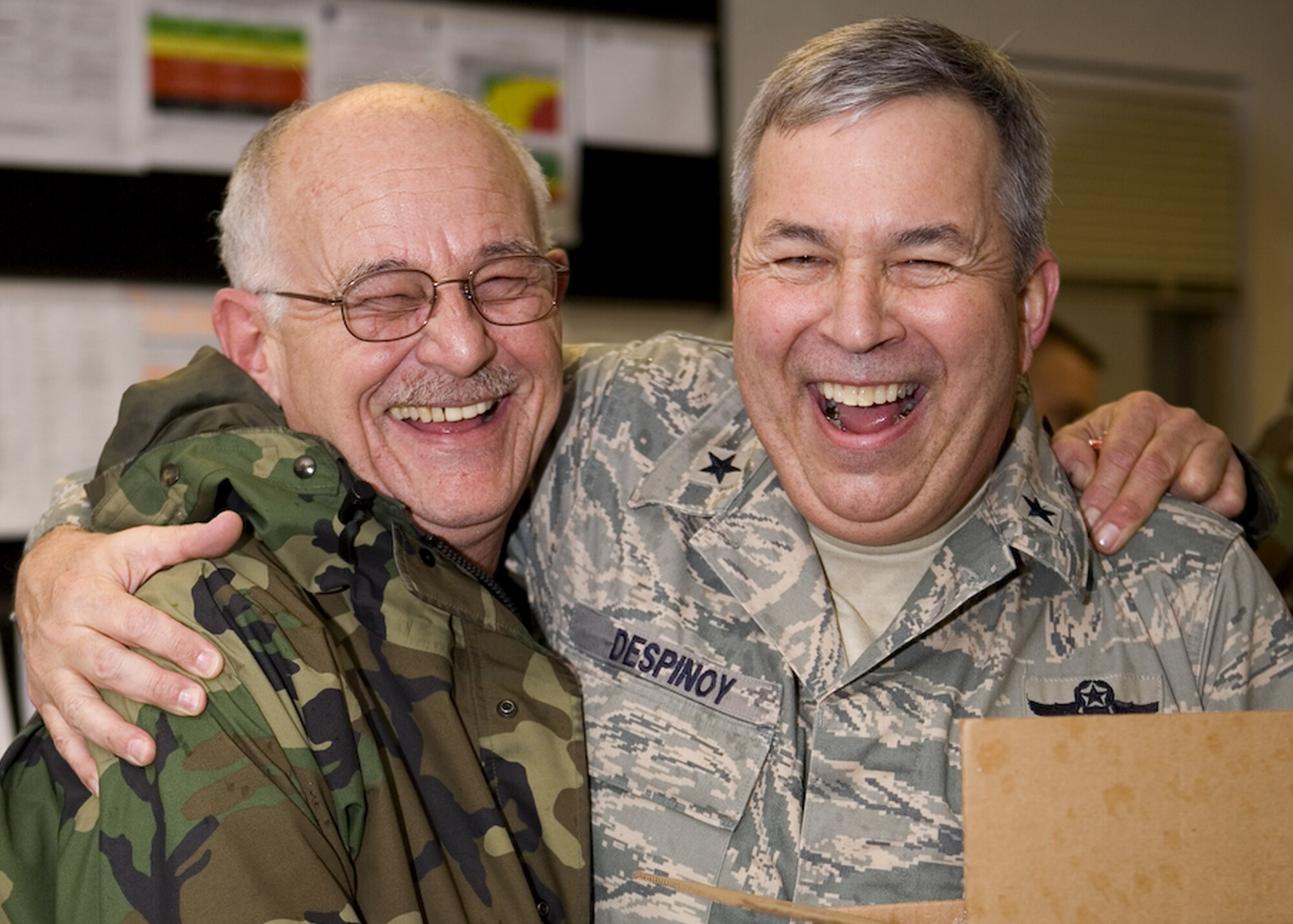 GRISSOM AIR RESERVE BASE, Ind., -- Brig. Gen. Dean Despinoy, 434th Air Refueling Wing commander, right, shares a laugh with Master Sgt. Larry Massey, a crew chief with the 434th Aircraft Maintenance Squadron, during the December unit training assembly. General Despinoy and other wing leadership passed out candy canes to Airmen on base before members signed out on Sunday. (U.S. Air Force photo/Senior Airman Omar Delacruz)