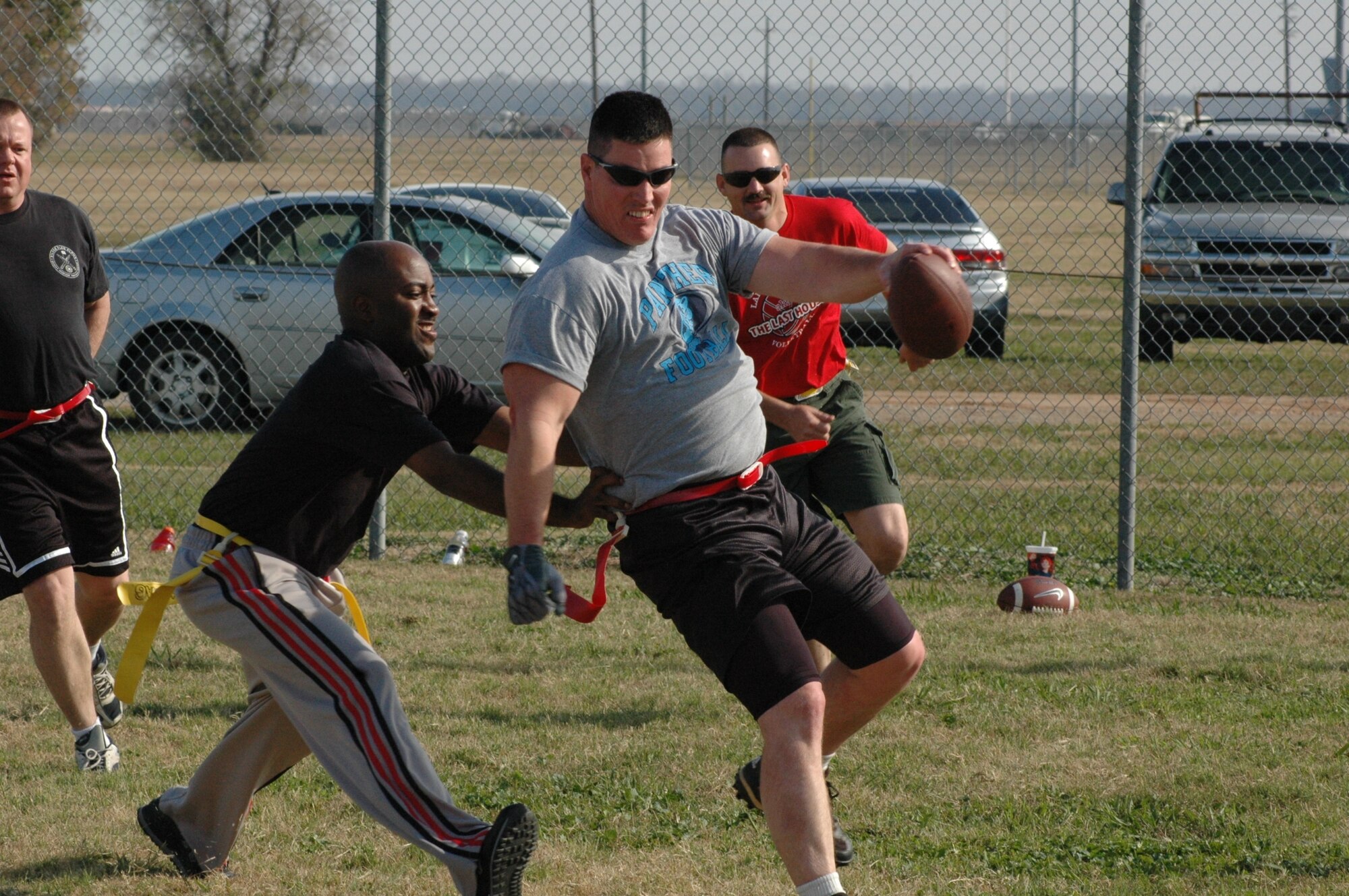 Flag footbal rules specifically state - NO tickling the quarterback while he is in motion and in possession of the ball. (U.S. Air Force photo/Tech. Sgt. Jeff Walston)
